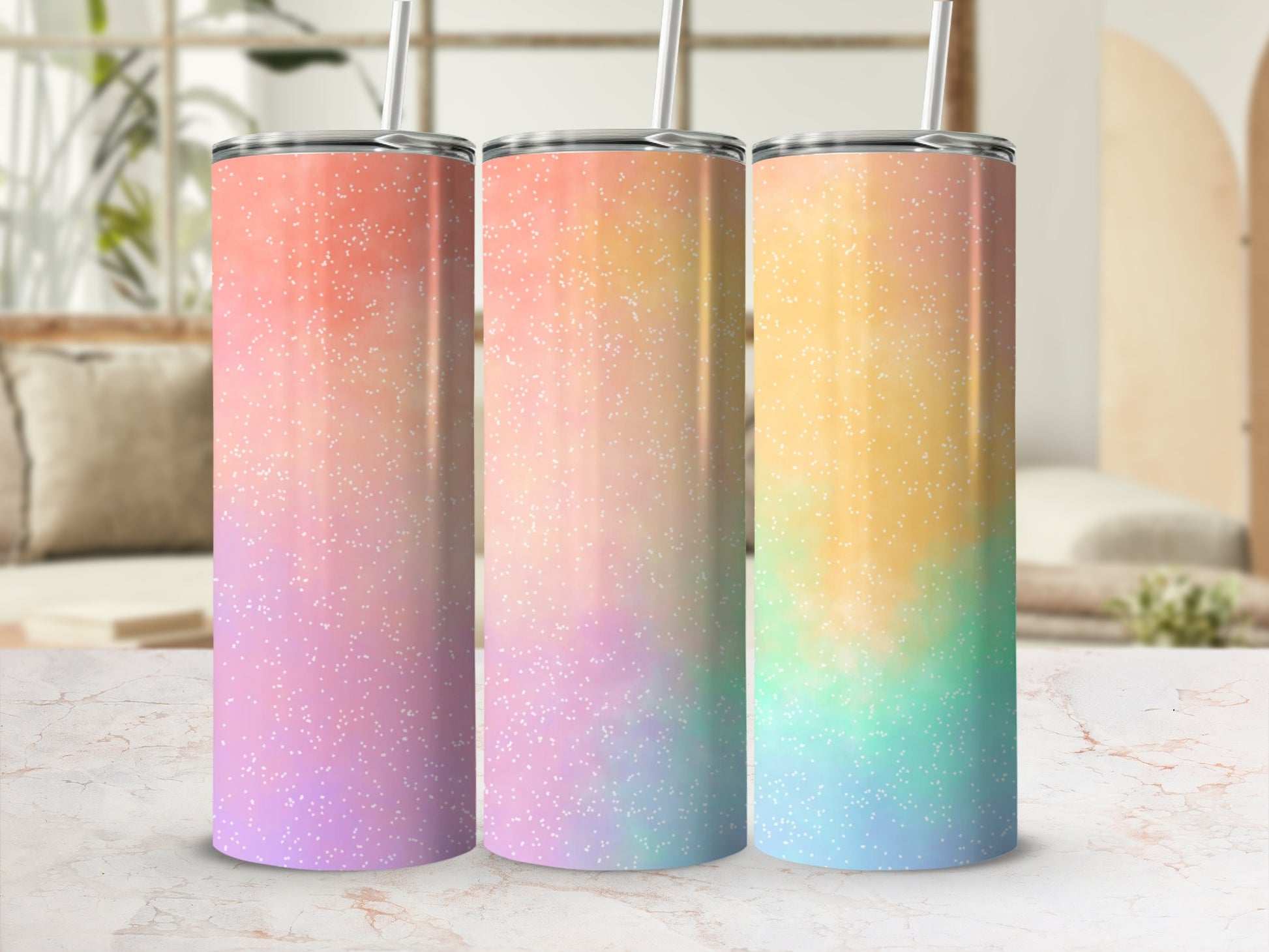 Three tumblers with pastel ombre glitter patterns and straws.