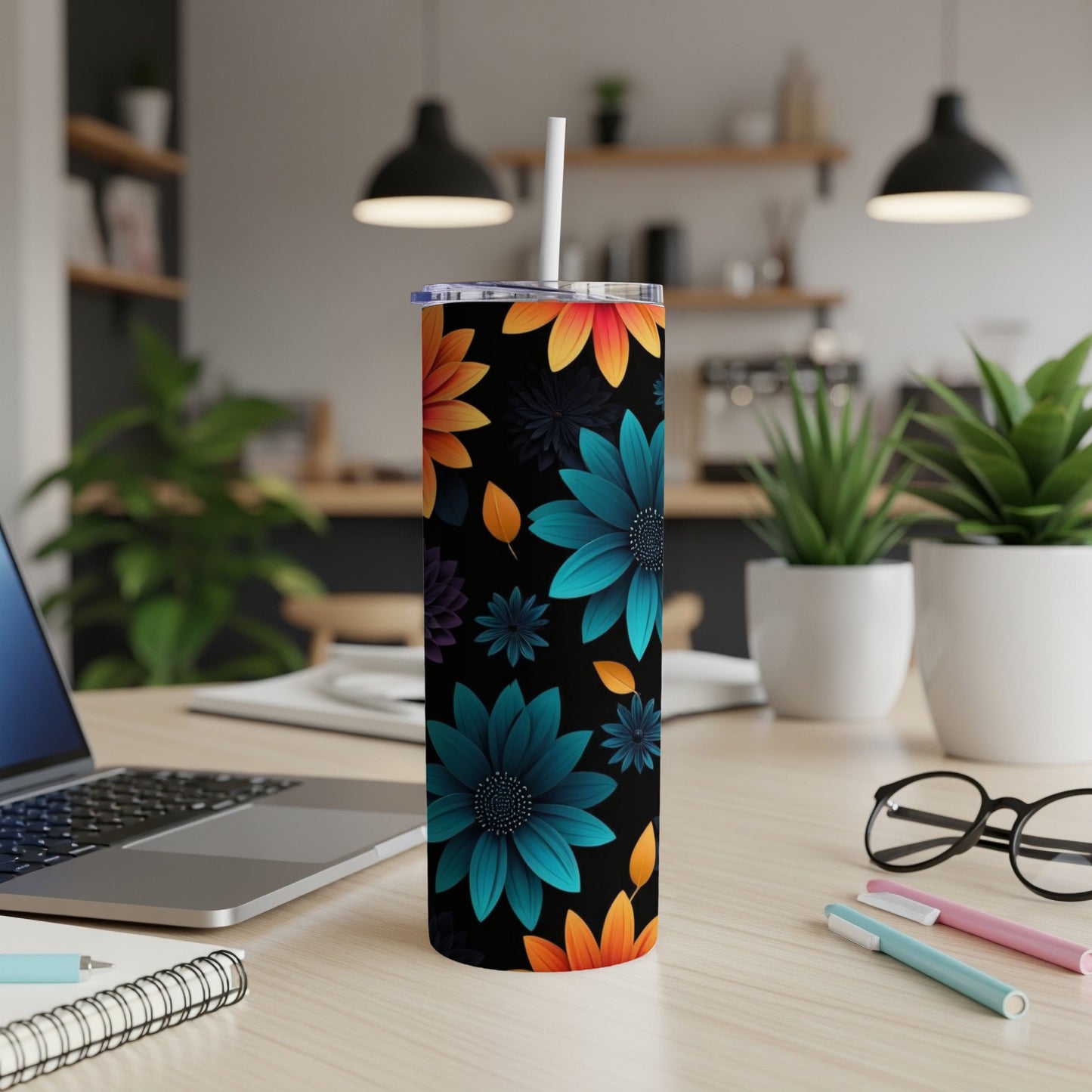 Tumbler with colorful floral pattern on a desk.