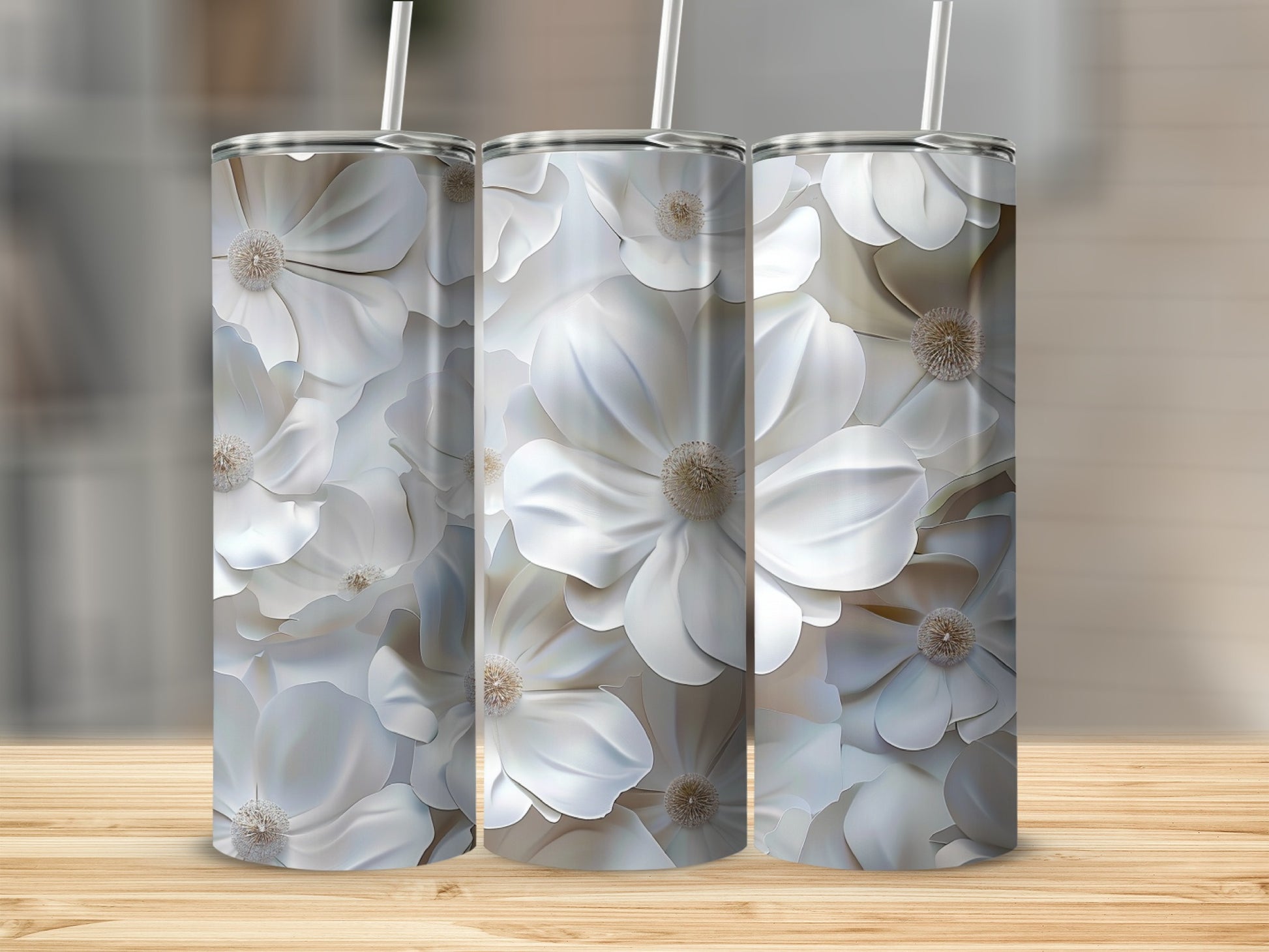 Three tall tumblers with a white floral pattern sit on a wooden surface.