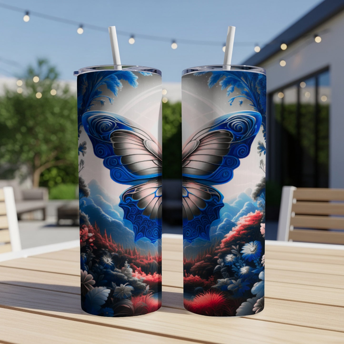Two blue butterfly tumblers on a table with a garden background.