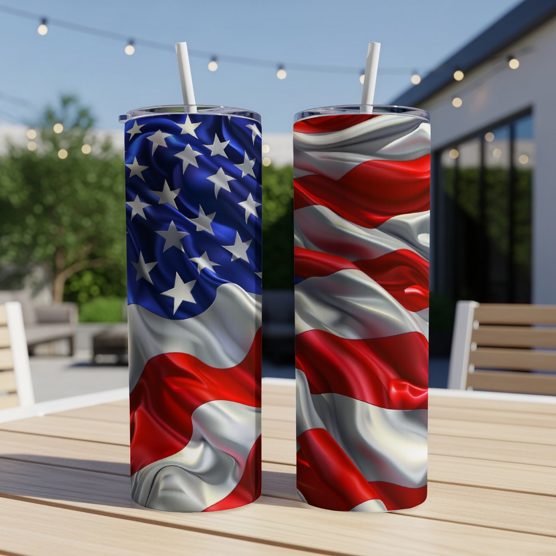Two tumblers with American flag design on a wooden table outdoors.