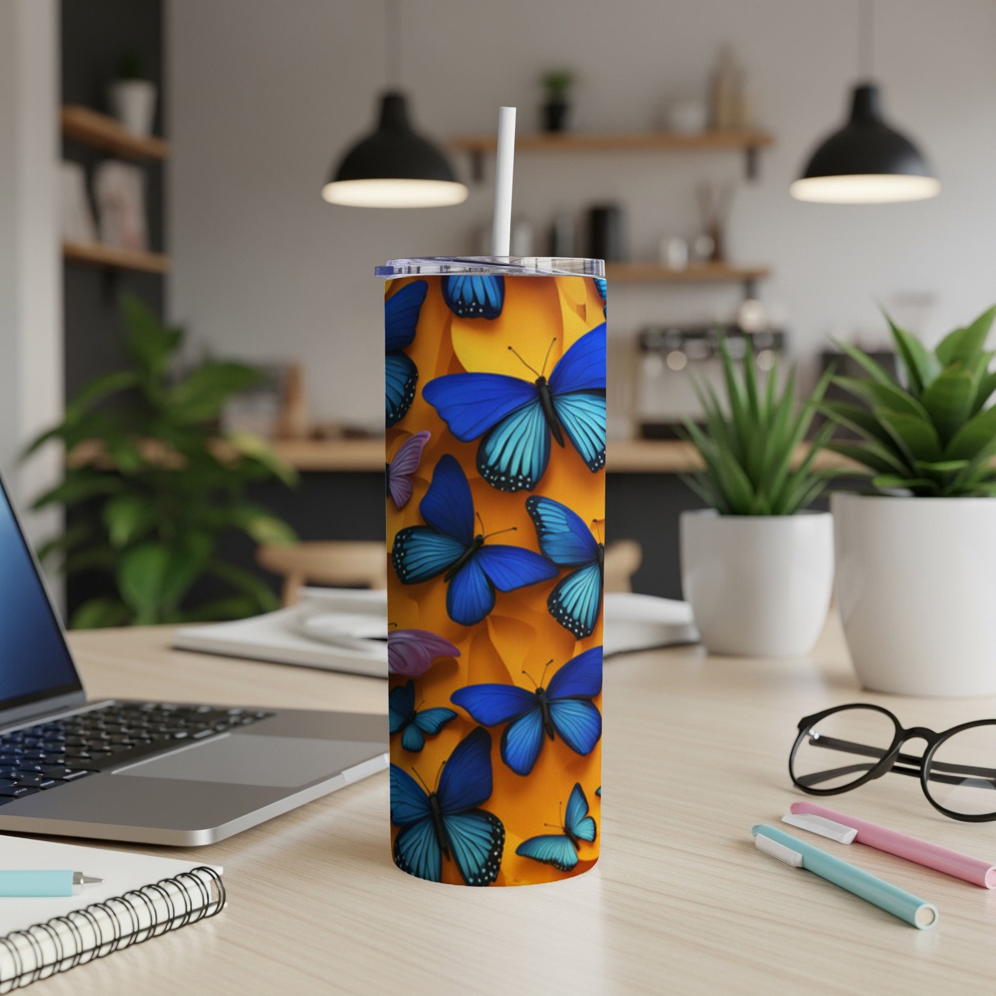 Tall tumbler with blue butterflies on an orange background.