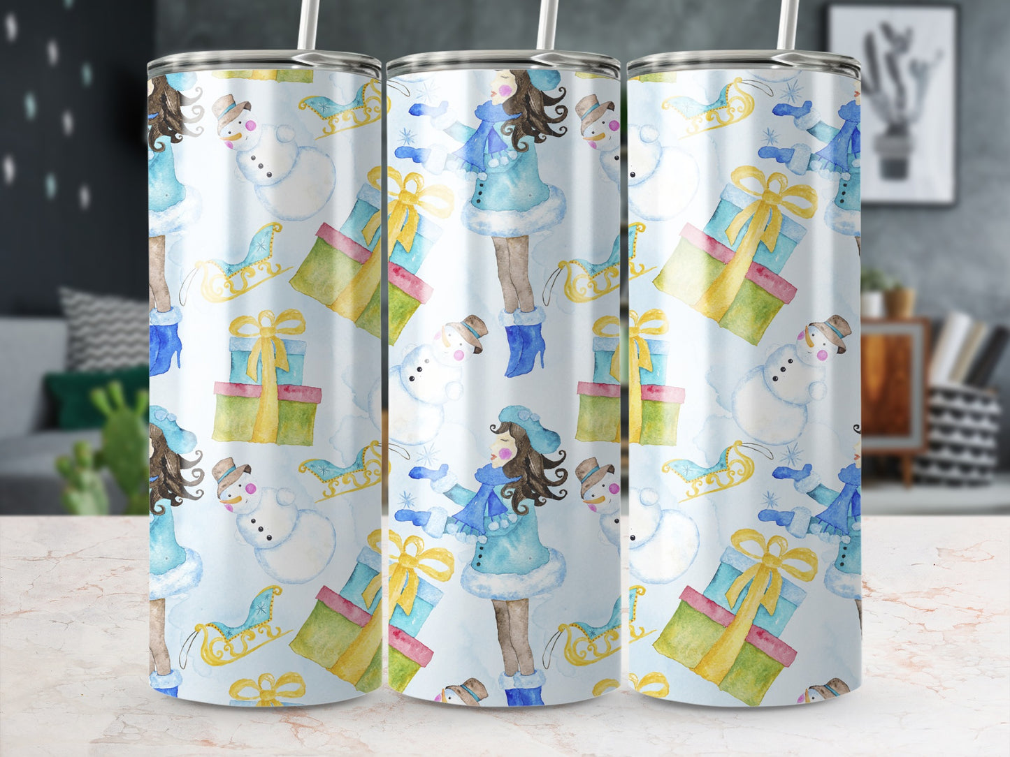 Three tumblers with a watercolor Christmas pattern featuring a girl, snowman, and gifts.