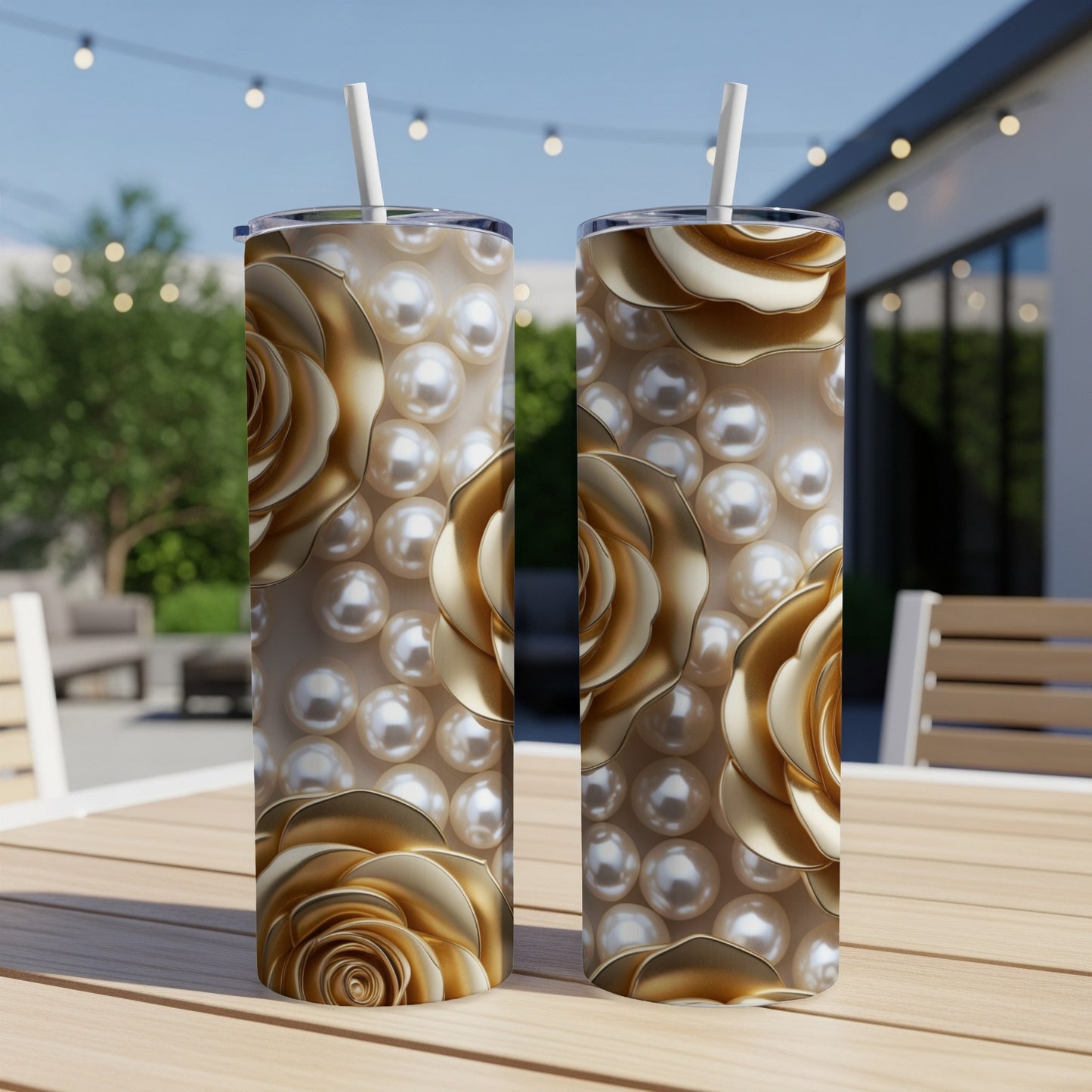 Two tall tumblers with gold roses and pearls on a wooden table.