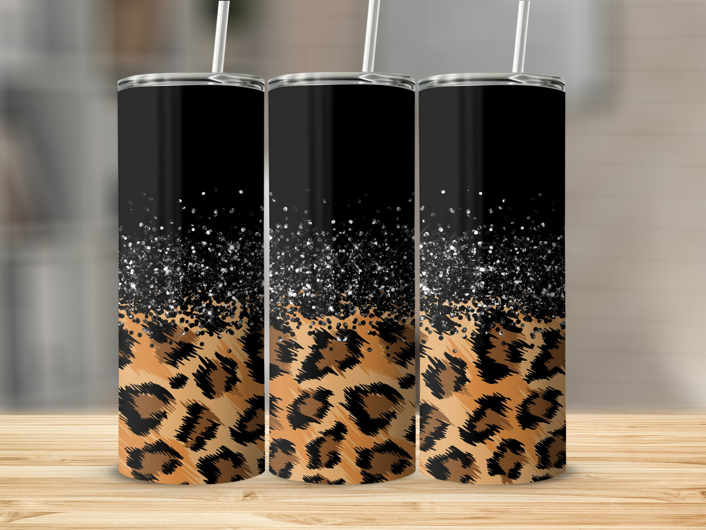 Three tumblers with black tops and leopard print bottoms.