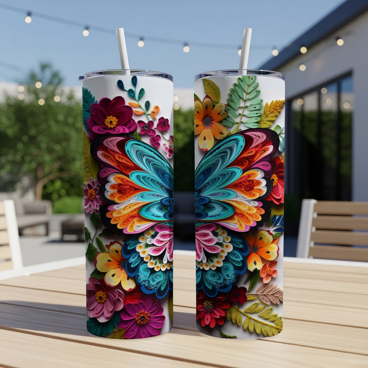 Two colorful butterfly-themed tumblers with floral designs sit on a wooden table.