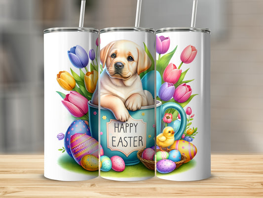 Labrador puppy in a mug surrounded by Easter eggs and tulips.