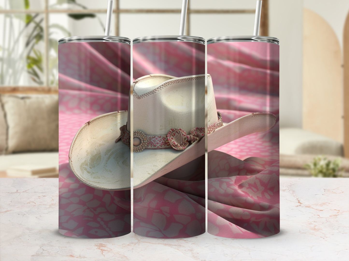 Cowboy hat with pink floral pattern on a marble surface.