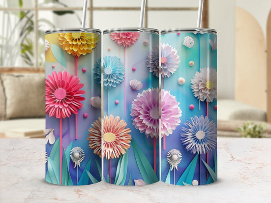 Three tall tumblers with colorful floral designs and straw lids.