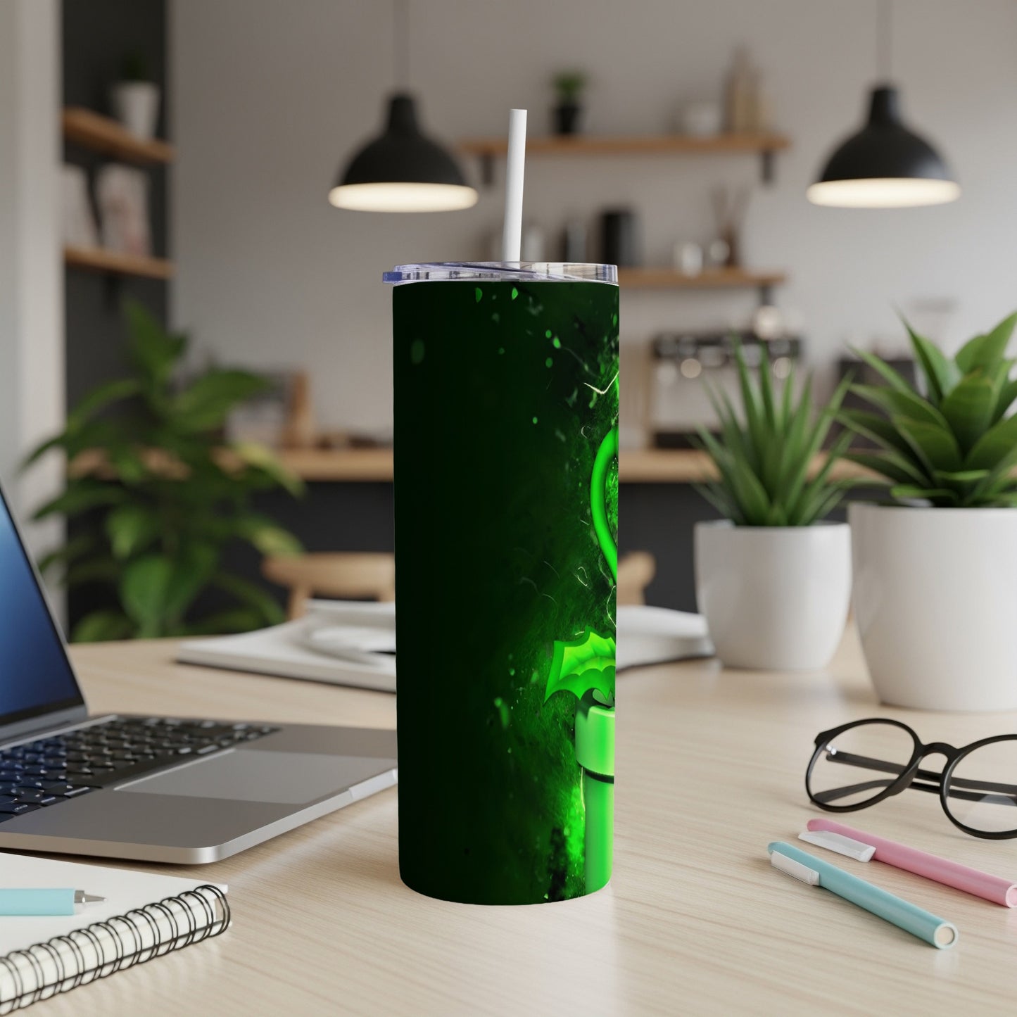 Green abstract pattern on a dark green tumbler with straw.