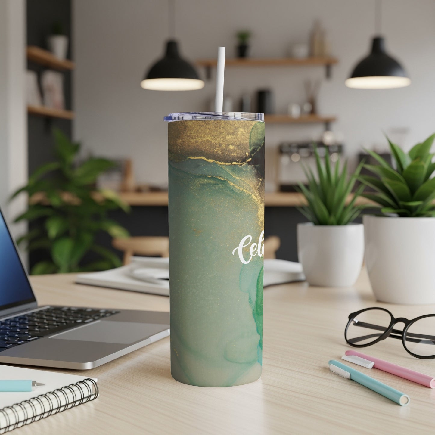 Green and gold marble skinny tumbler with a white straw and "Celtic" text.