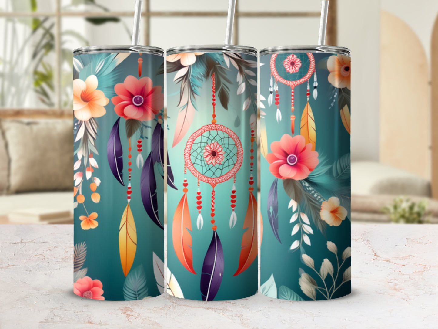 Three tumblers with floral and dreamcatcher designs on a marble surface.