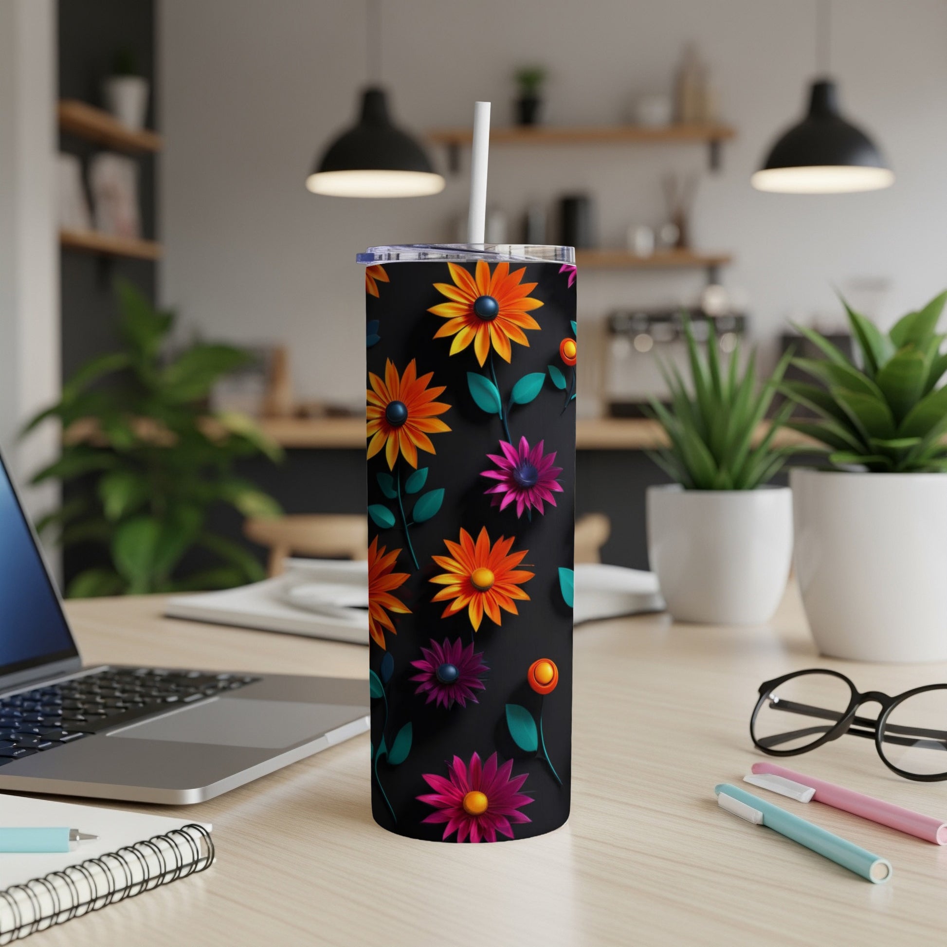Black tumbler with colorful floral pattern and white straw.