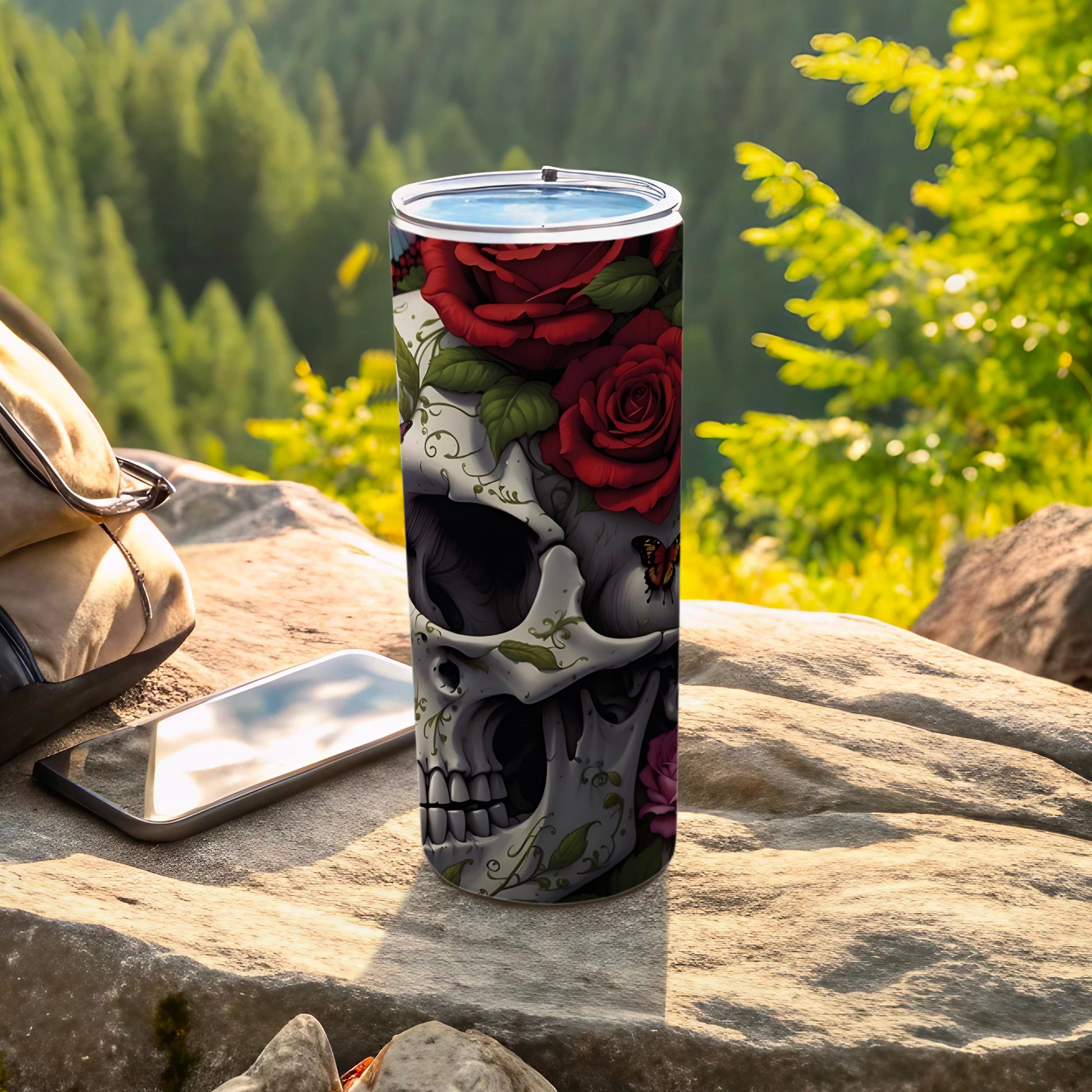 Skull and rose design on a stainless steel tumbler with a butterfly.