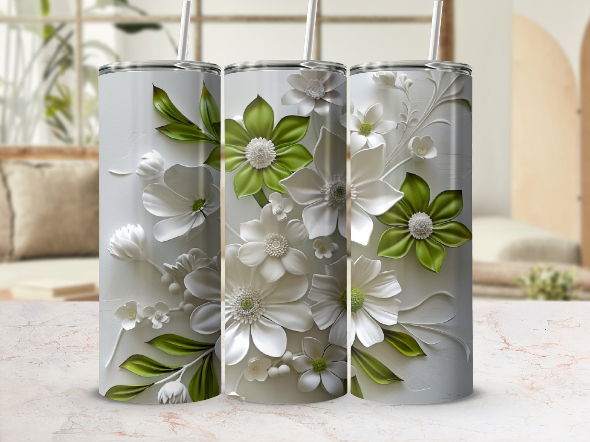 Three white tumblers with embossed green and white flowers and leaves.