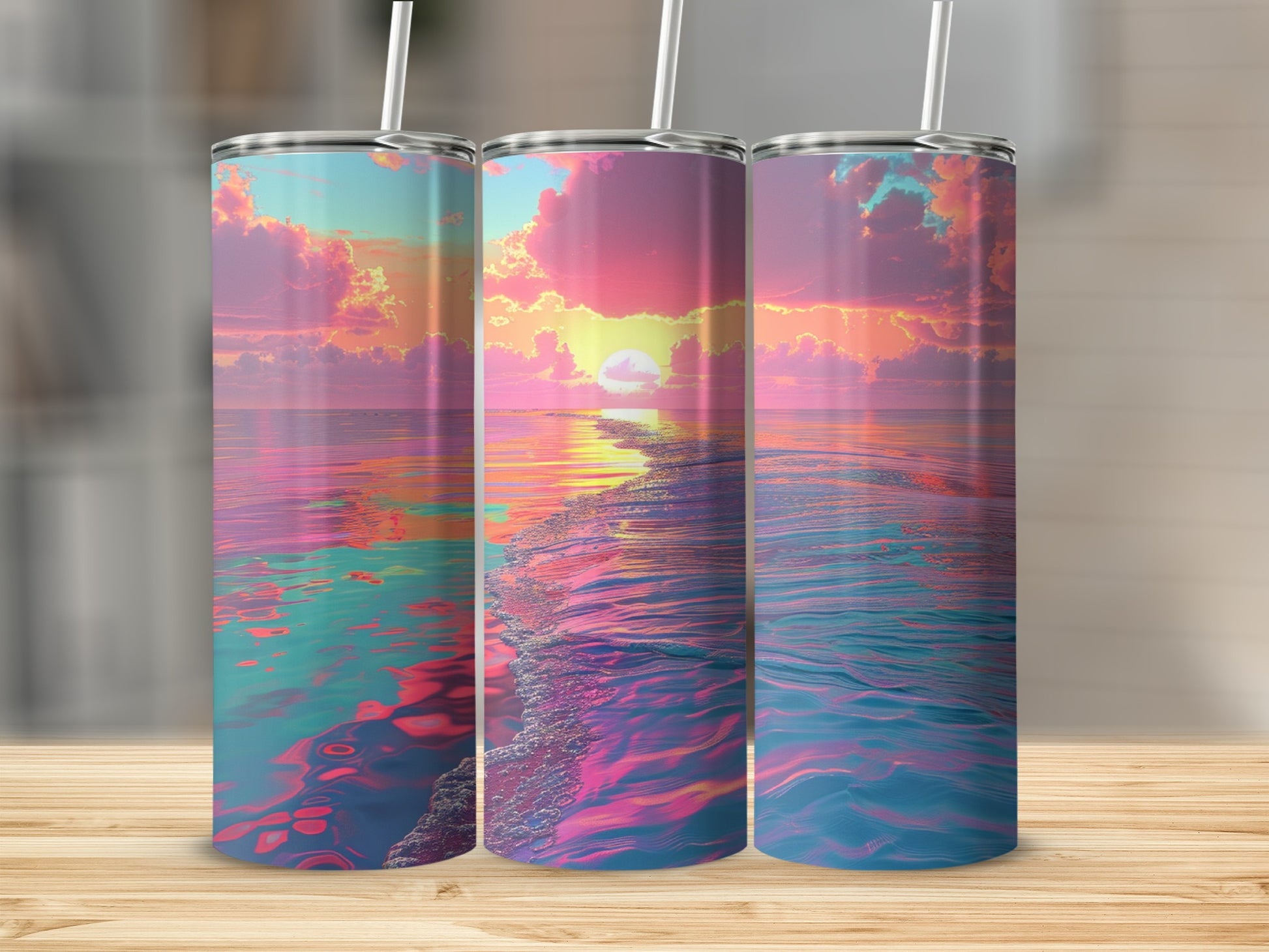 Three tumblers featuring a vibrant sunset over a calm ocean.
