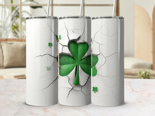 White tumbler with a cracked design and a large green shamrock.