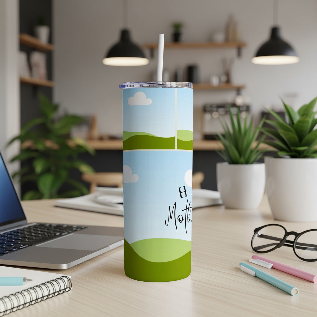 Tumbler with "Happy Mother" text and a landscape design on a desk.