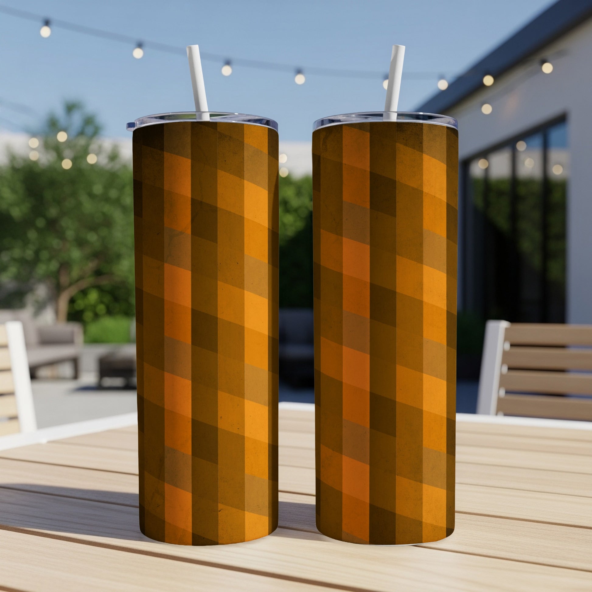 Two tall tumblers with a brown and orange striped pattern sit on a wooden table.