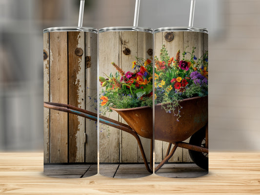 Rustic wheelbarrow overflowing with vibrant flowers against a weathered wood background.