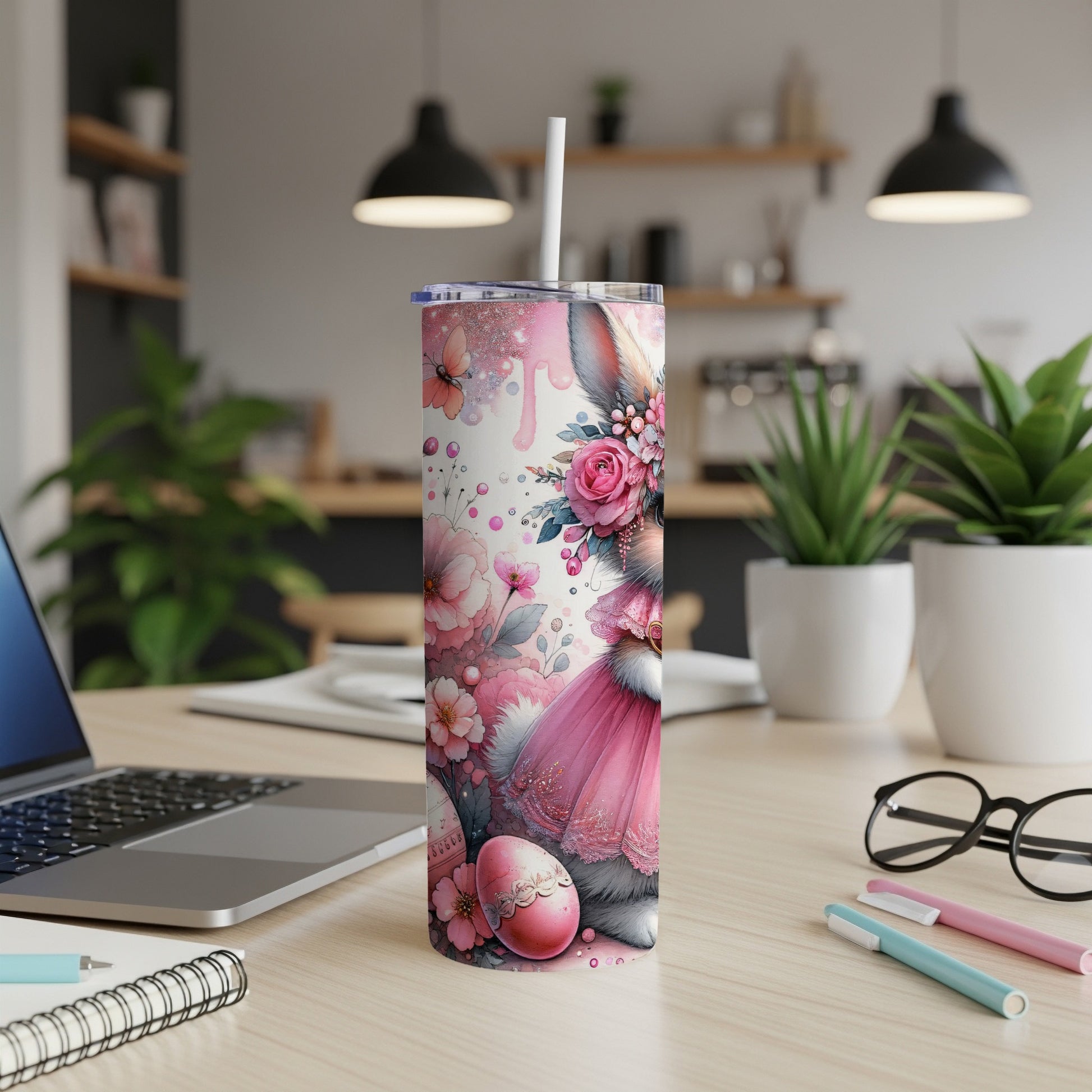 Pink bunny in a dress with flowers and Easter egg on a tumbler.