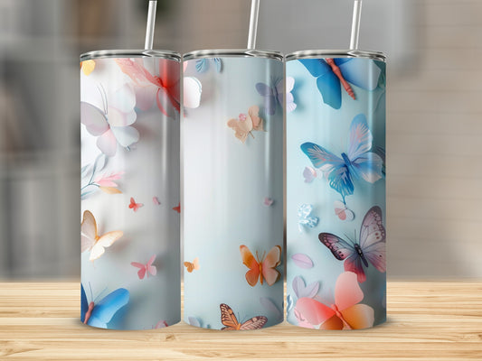 Three tumblers with butterfly designs on a wooden surface.