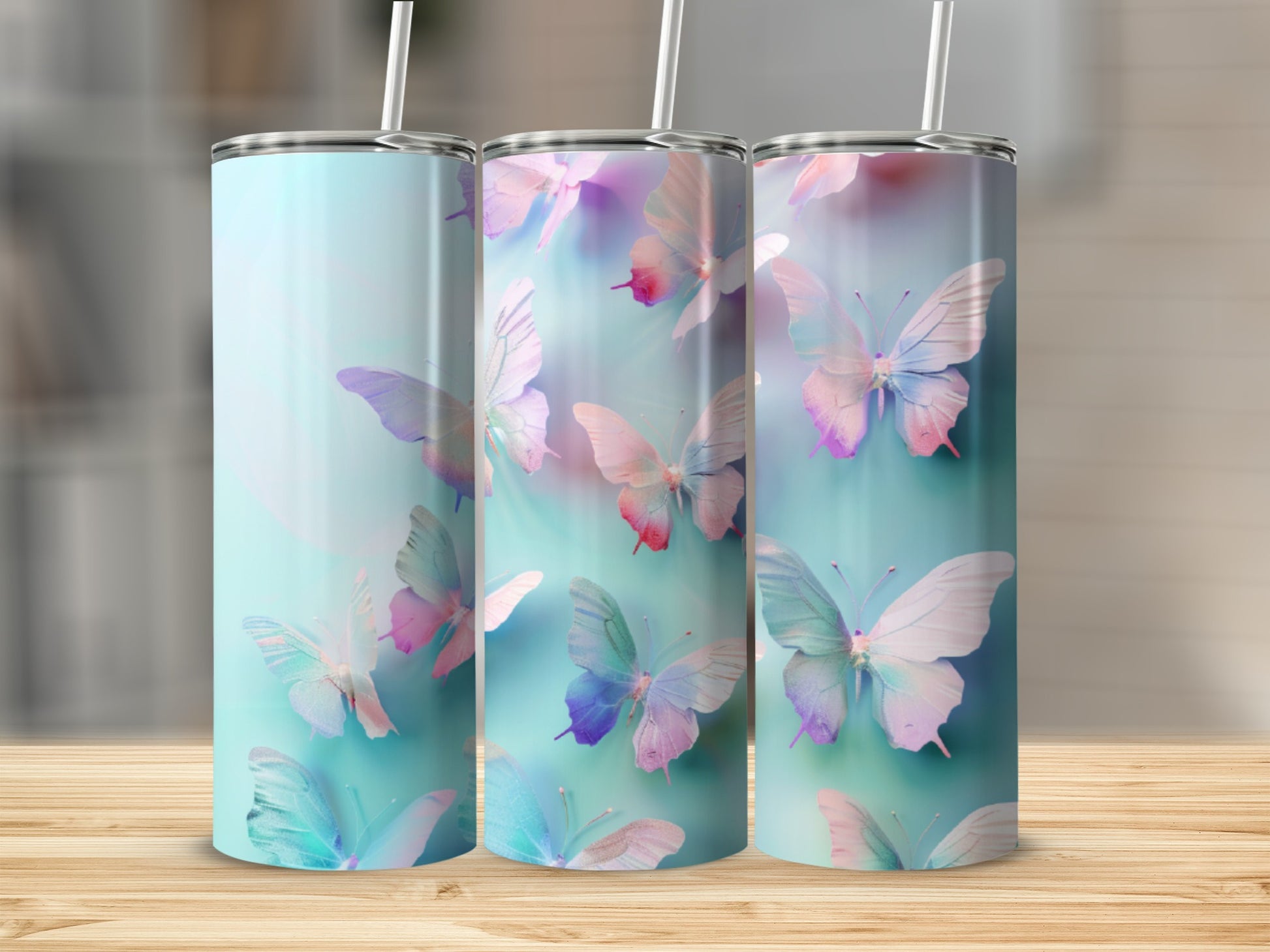 Three tumblers with colorful butterflies on a light blue background.