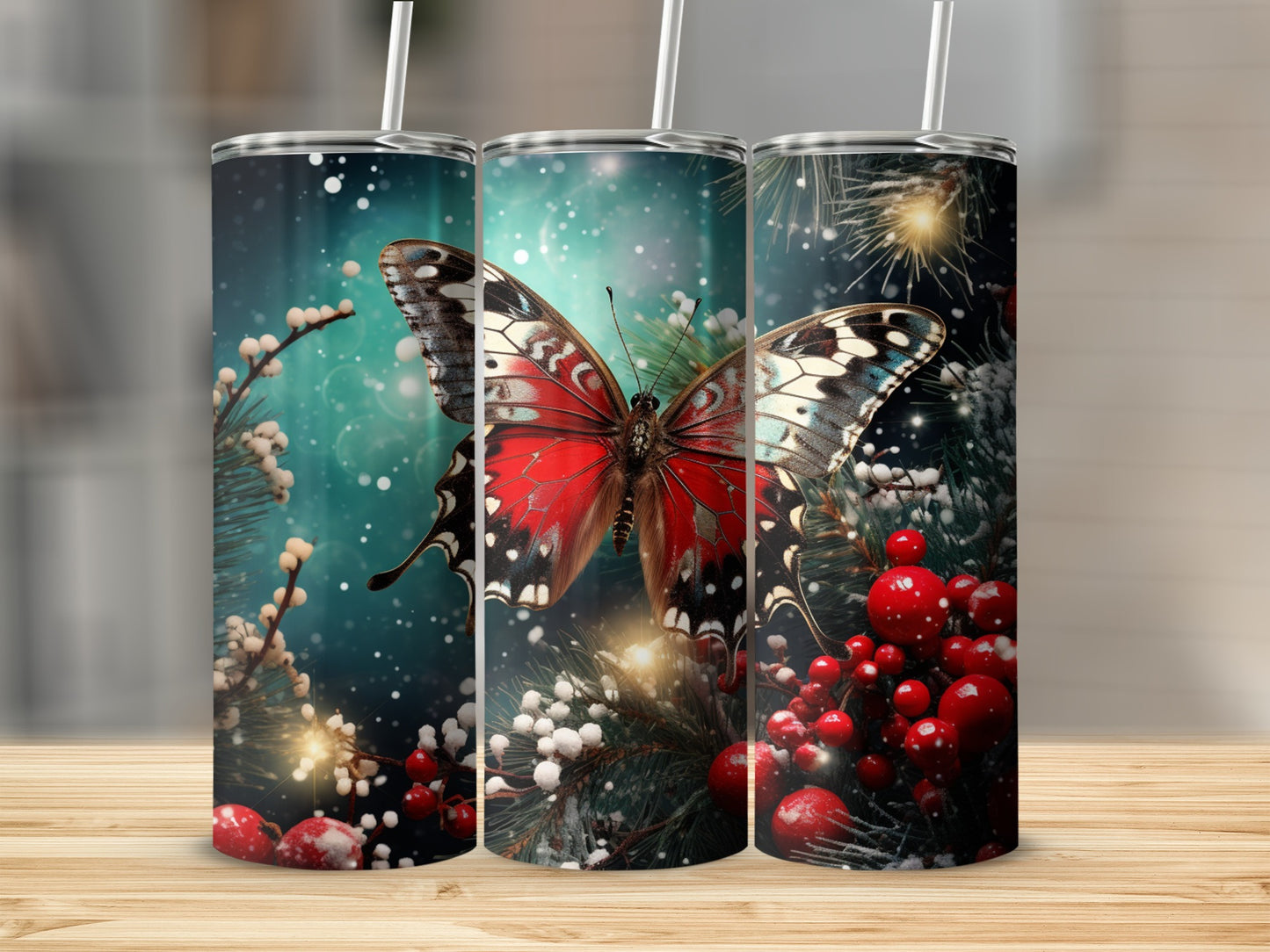 Three tumblers decorated with a red butterfly, berries, and pine branches.