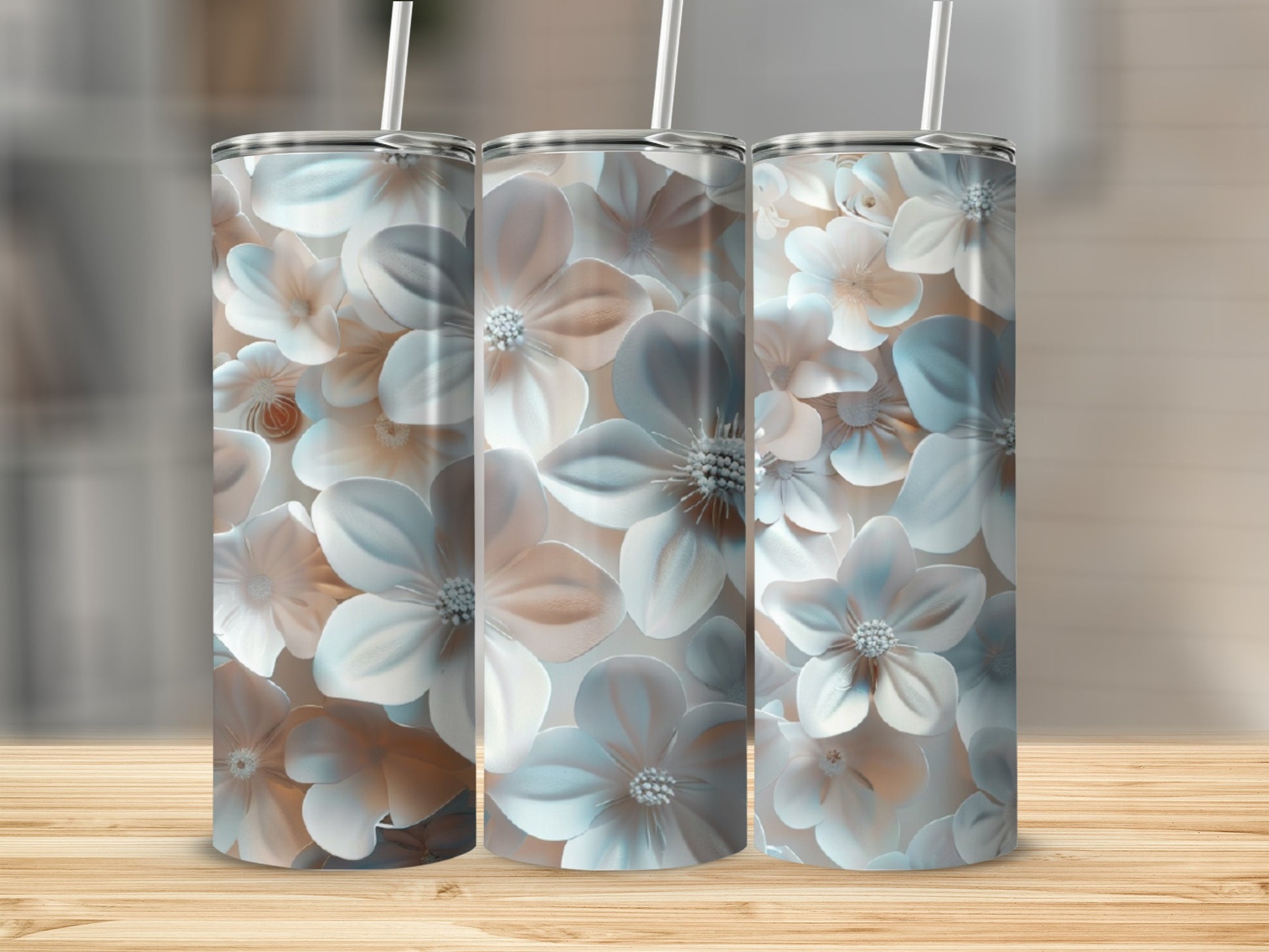 Three tumblers with a pastel floral pattern on a wooden surface.