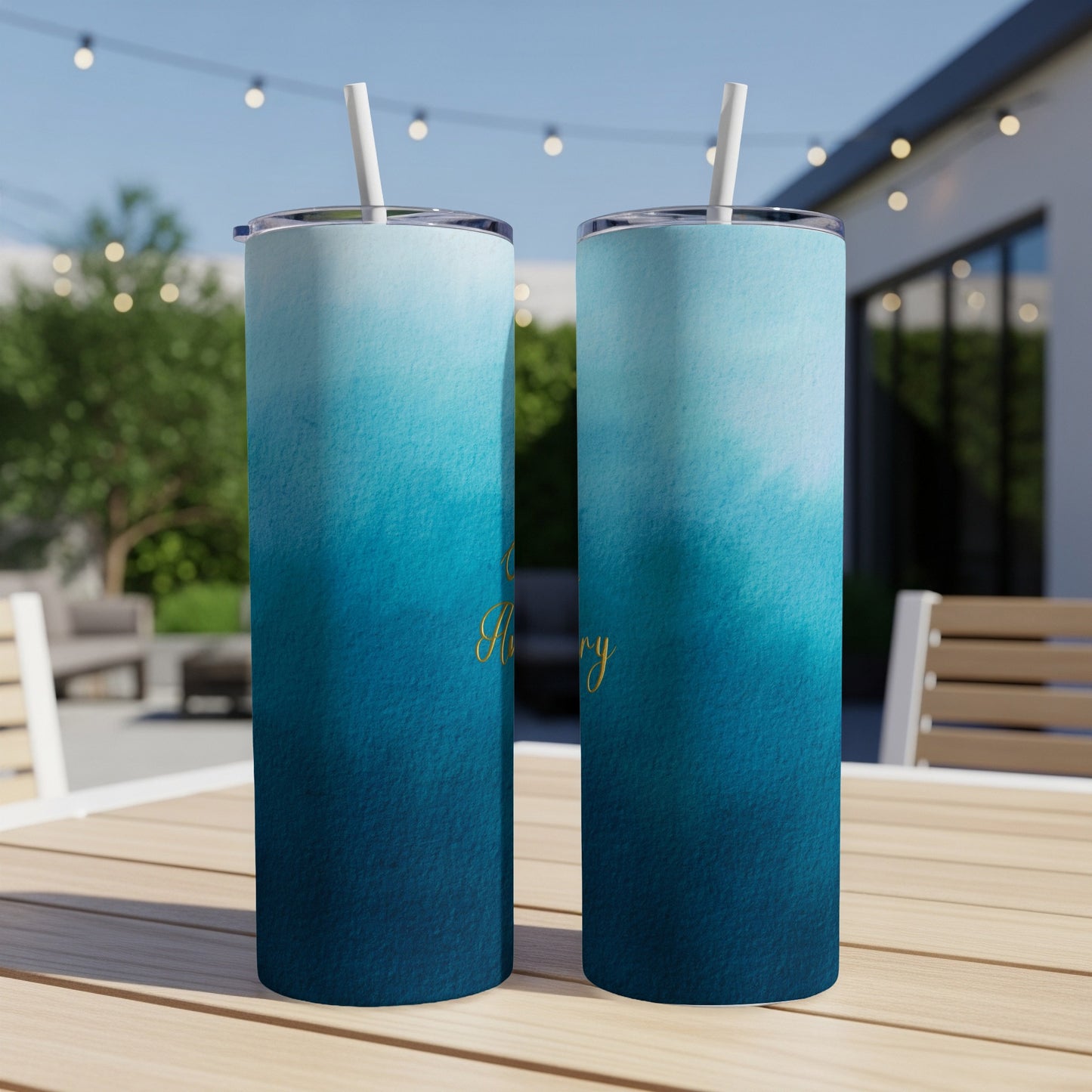 Two tall tumblers with a blue watercolor gradient design and gold script text.