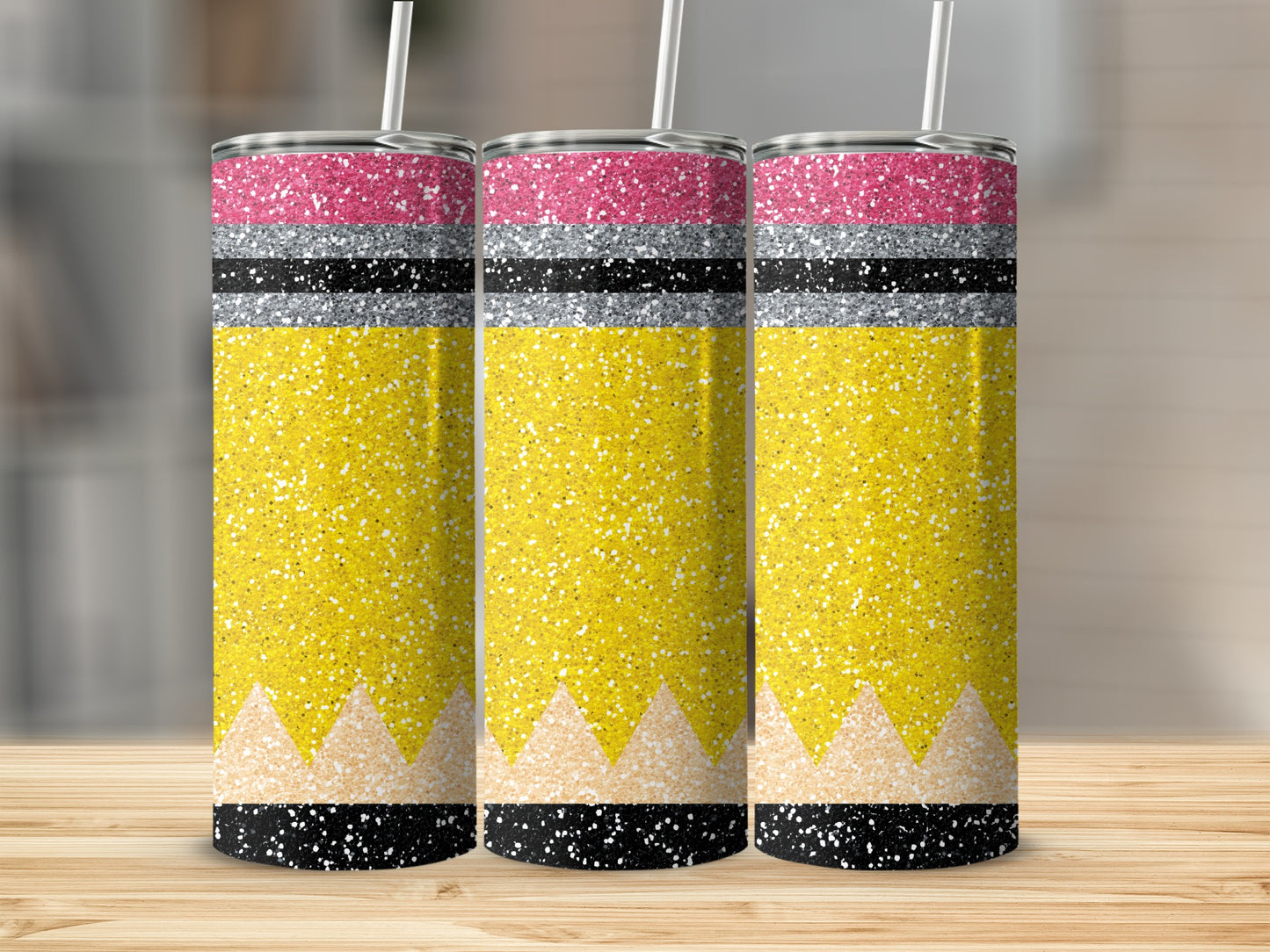 Three glitter pencils with yellow bodies and pink and silver bands.
