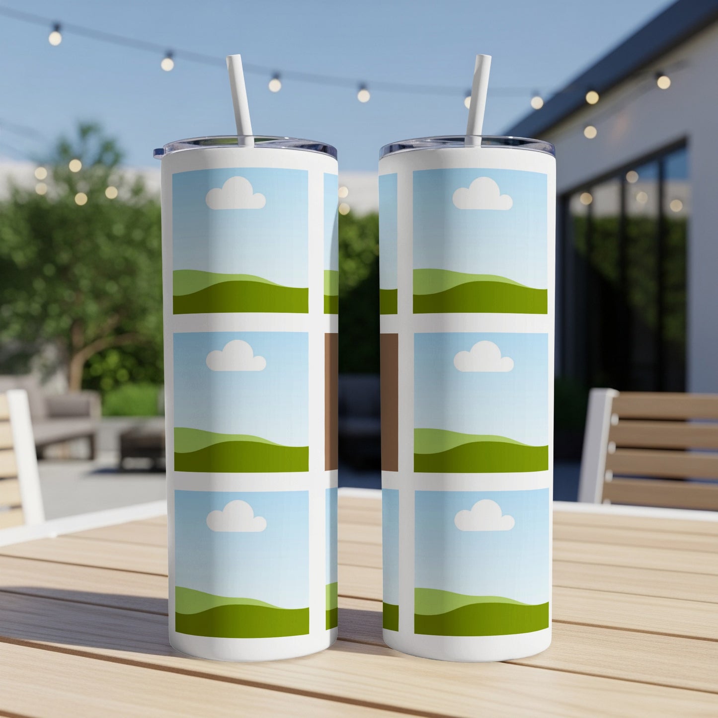 Two tumblers with a repeating pattern of landscape photos sit on a wooden table.