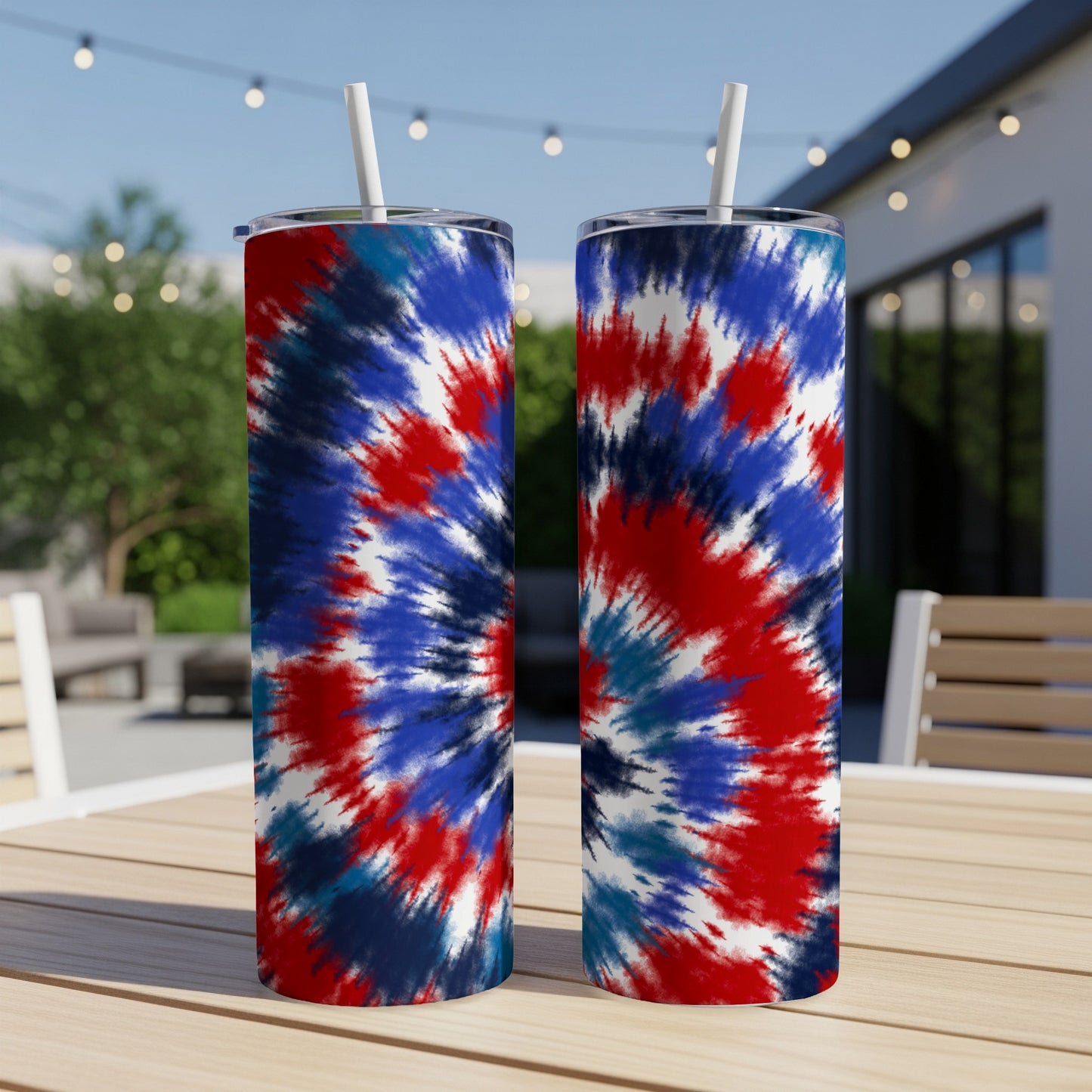 Two tumblers with red, white, and blue tie-dye pattern and white straws.