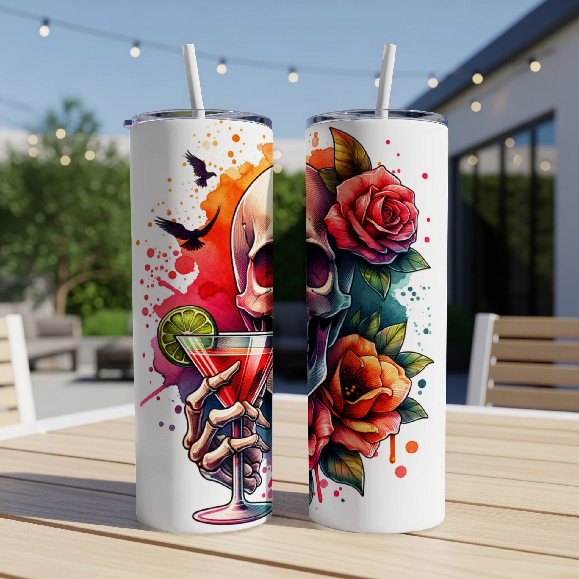 Two tumblers with skull, rose, and cocktail designs on a wooden table.