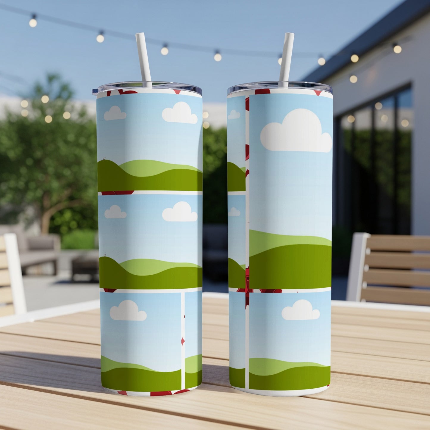 Two tumblers with a repeating farm landscape and cloud pattern, each with a straw.