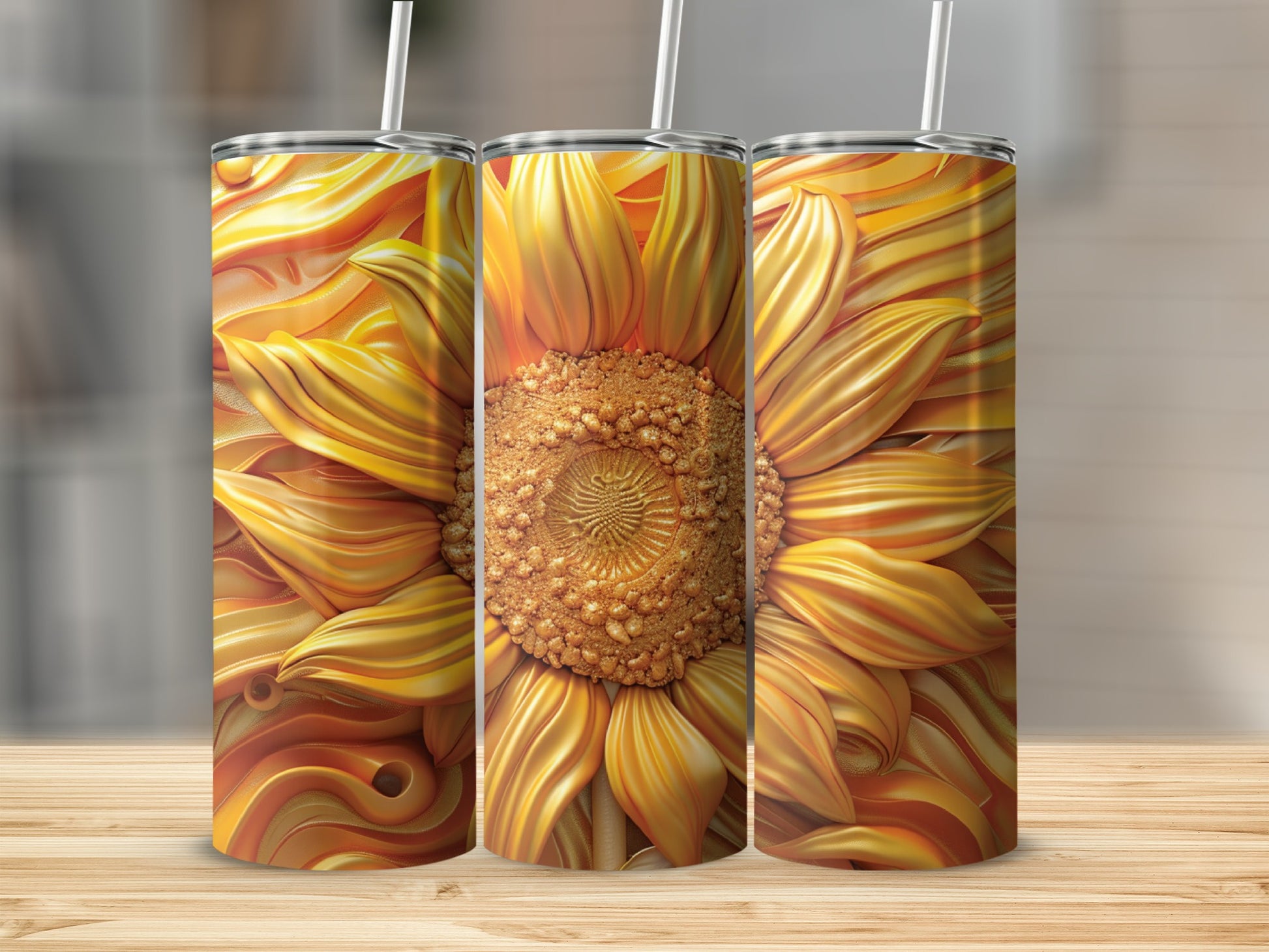 Three tumblers with a golden sunflower design sit on a wooden surface.