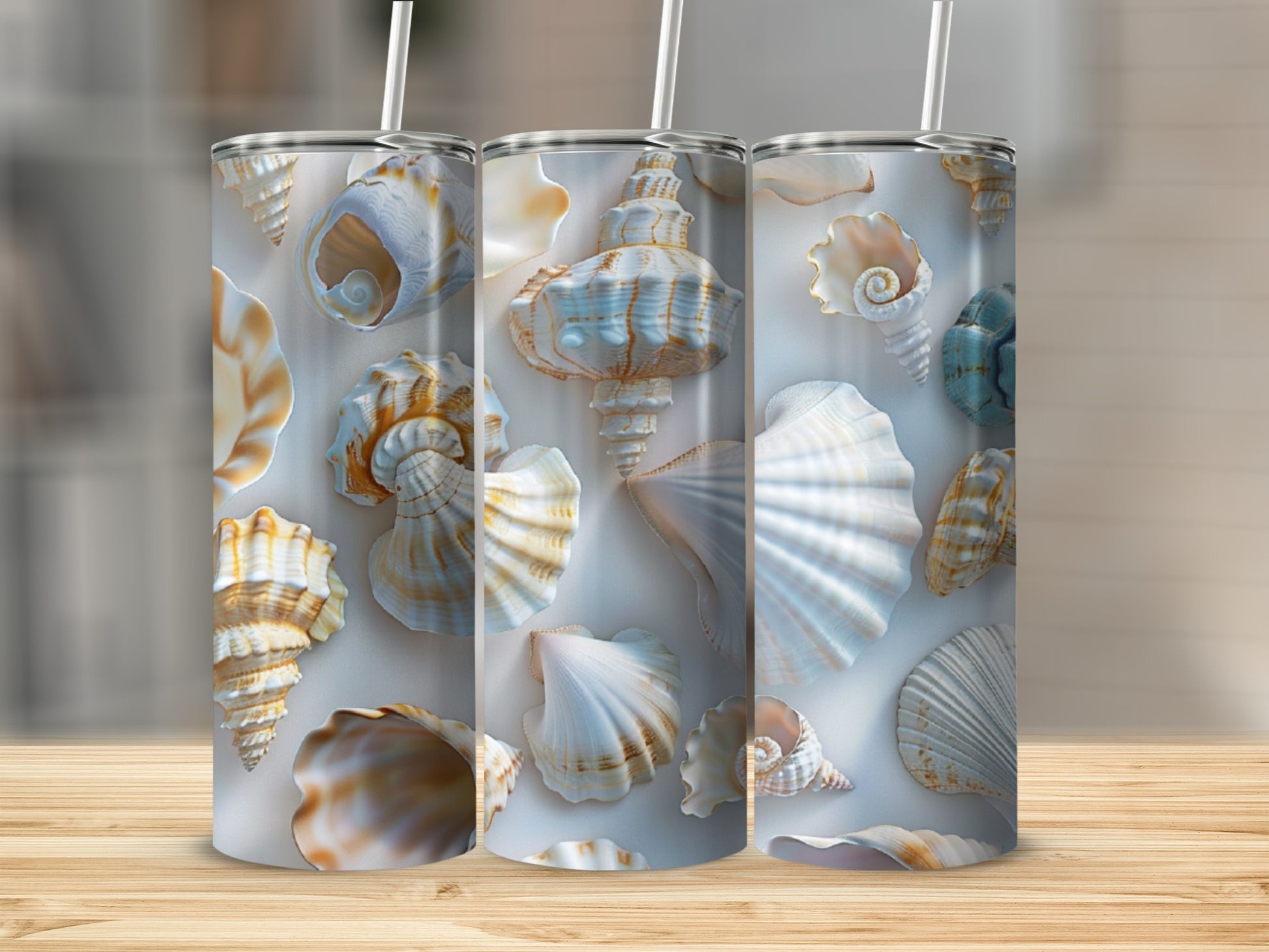 Three tumblers with a seashell pattern, placed on a wooden surface.