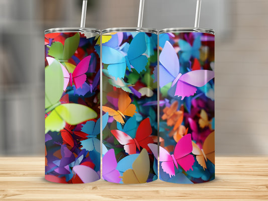Three tumblers with colorful butterfly patterns on a wooden surface.