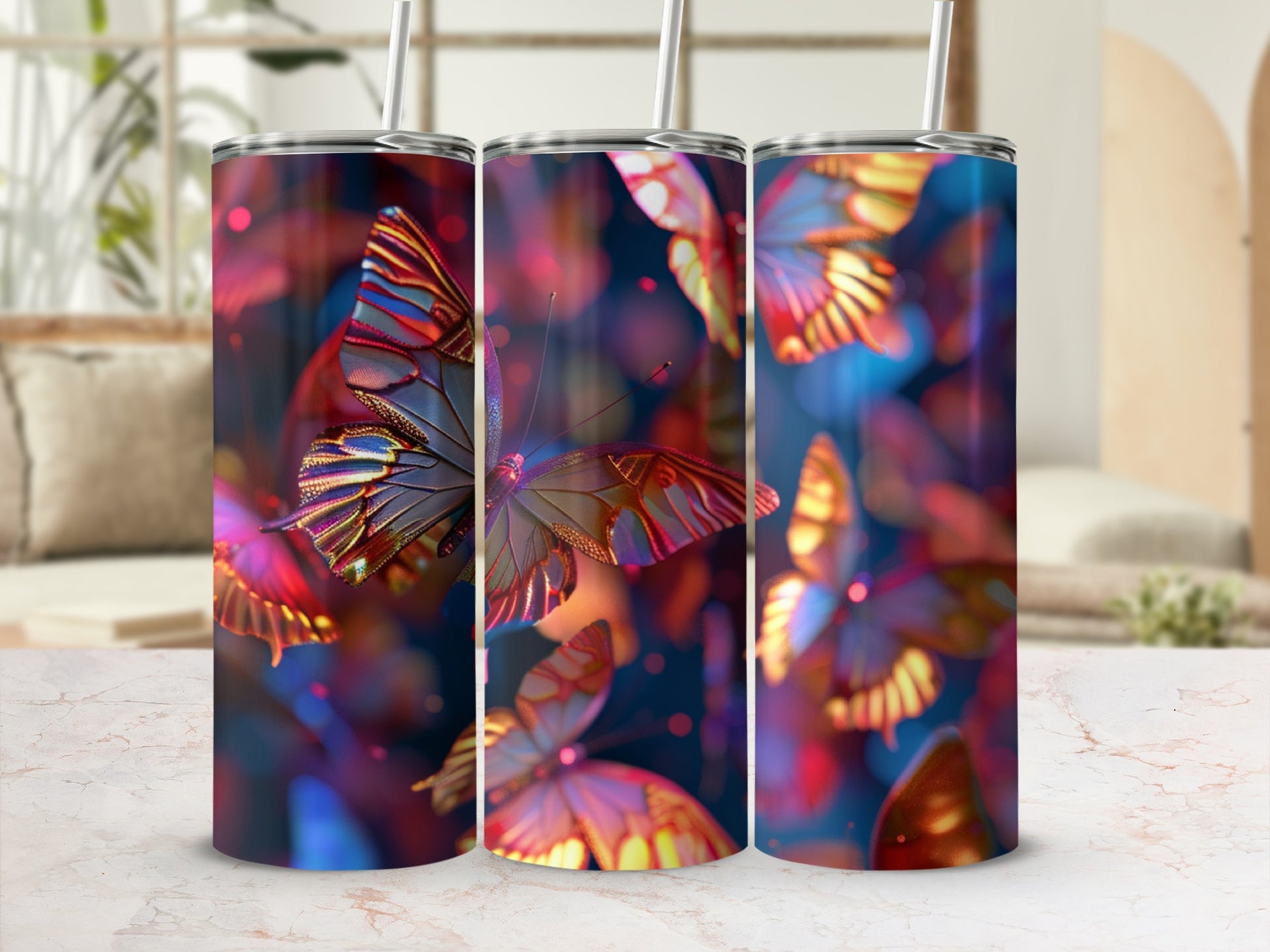 Three tumblers with colorful butterfly designs displayed on a marbled surface.