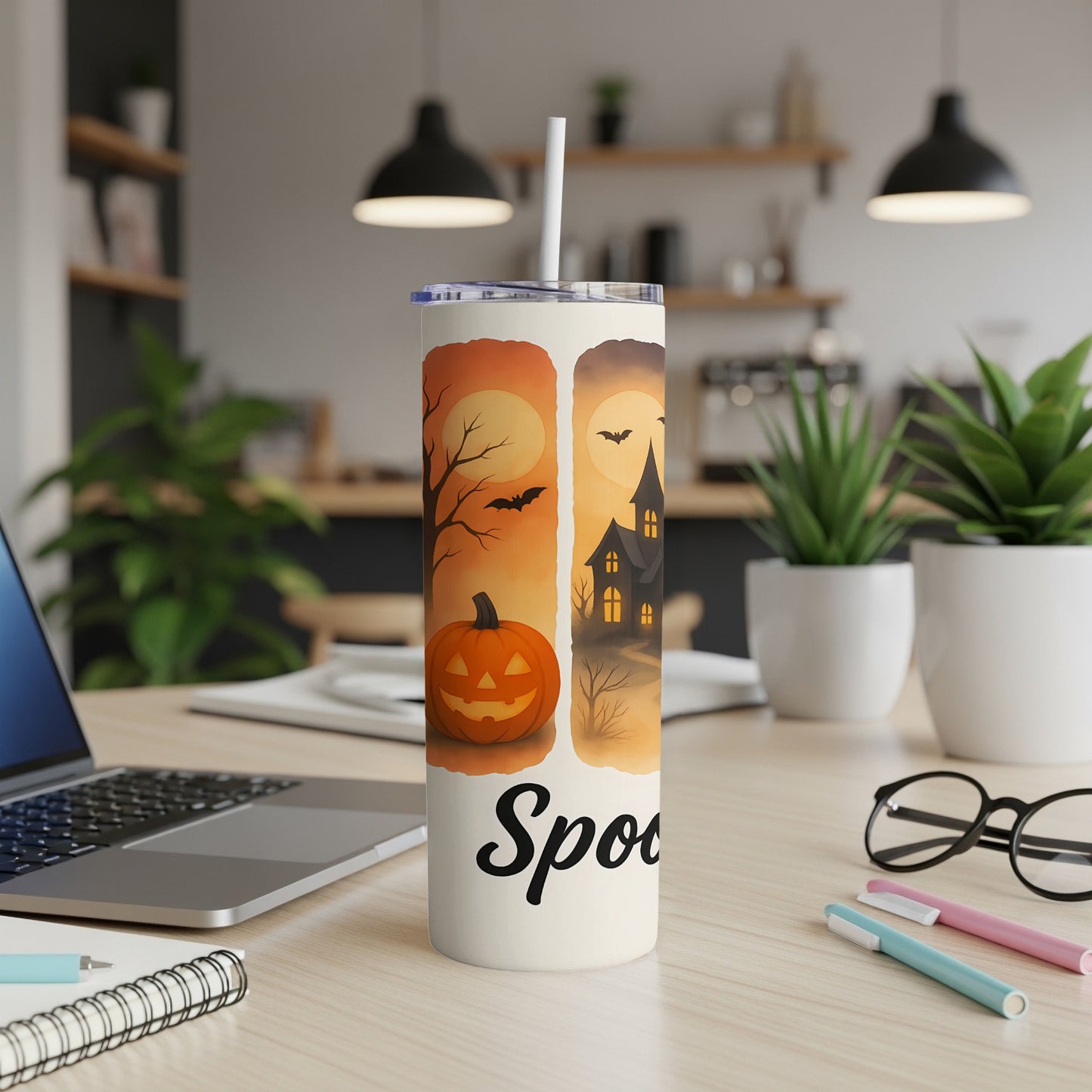 White tumbler with Halloween design and "Spooky" text.