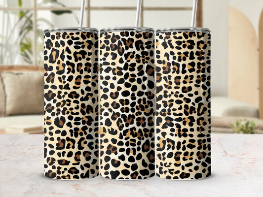 Three tumblers with a leopard print pattern sit on a marble surface.