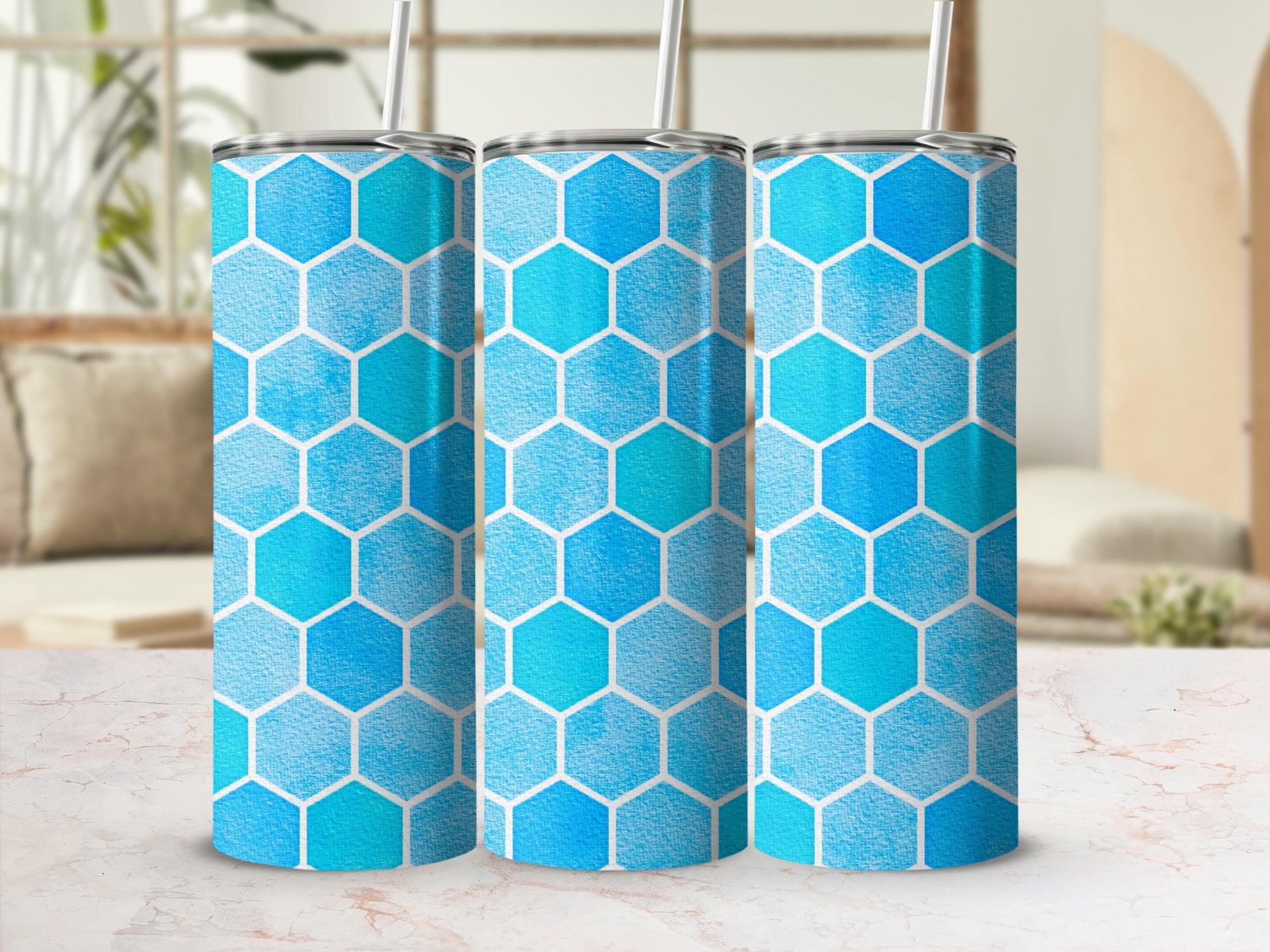 Three tumblers with blue and teal honeycomb pattern and straws.