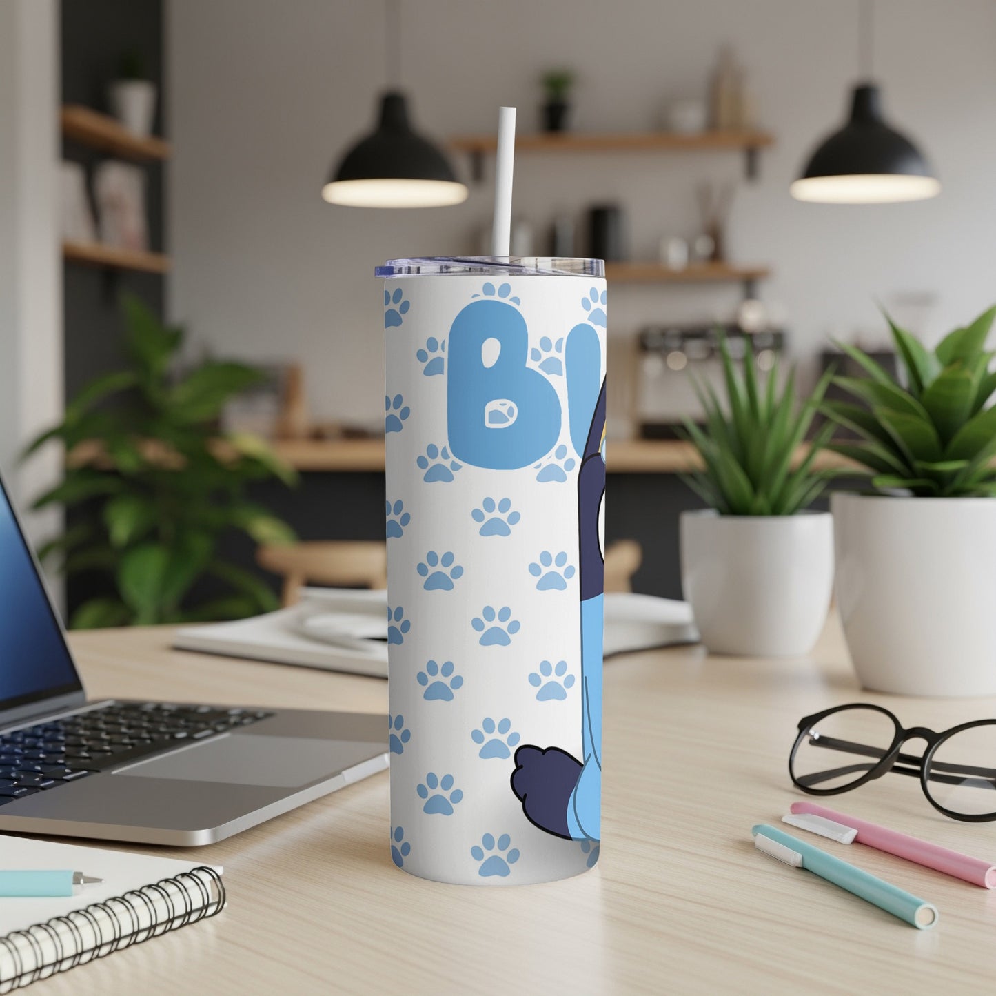 Bluey character on white tumbler with paw prints and straw.