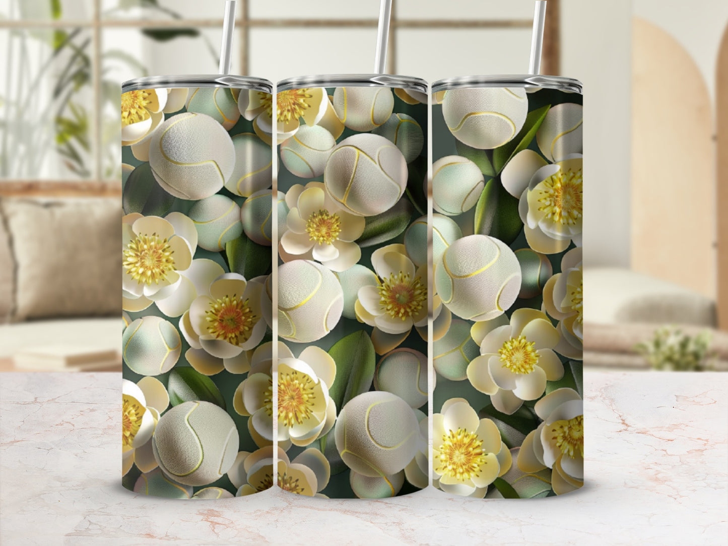 Floral tennis balls pattern on three tumblers with straws.