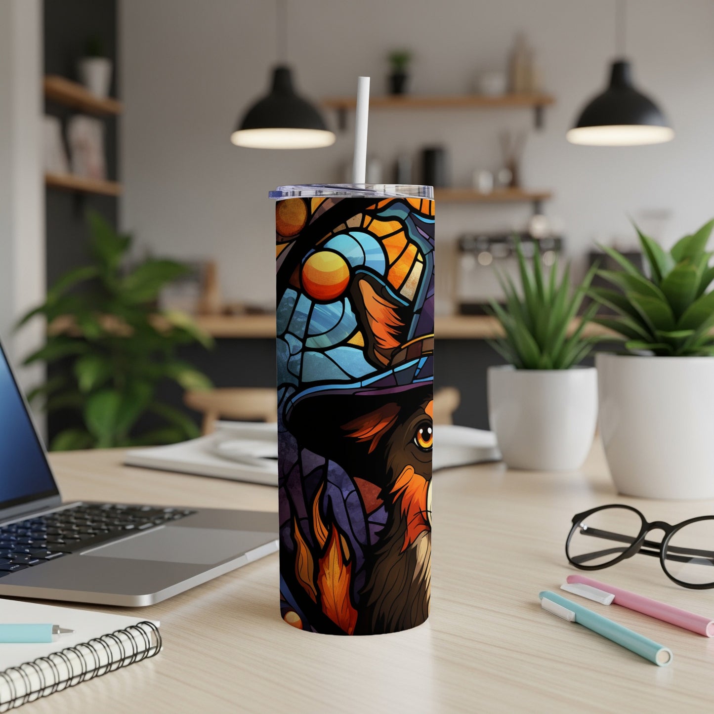 Dog wearing a witch hat on a stained glass tumbler with straw.