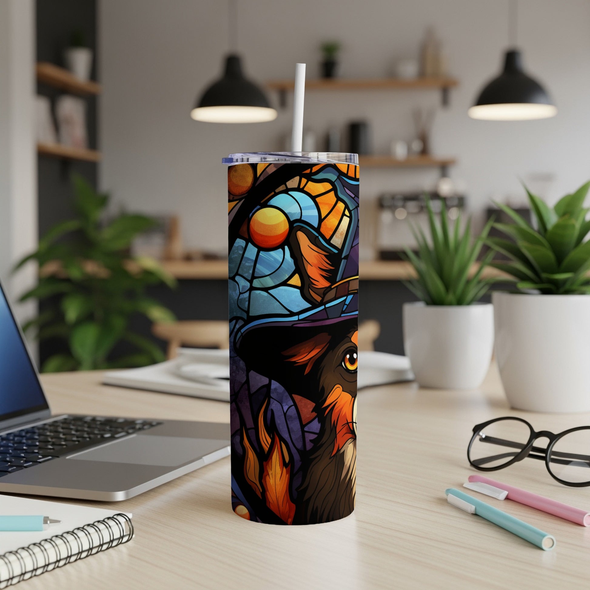 Dog wearing a witch hat on a stained glass tumbler with straw.