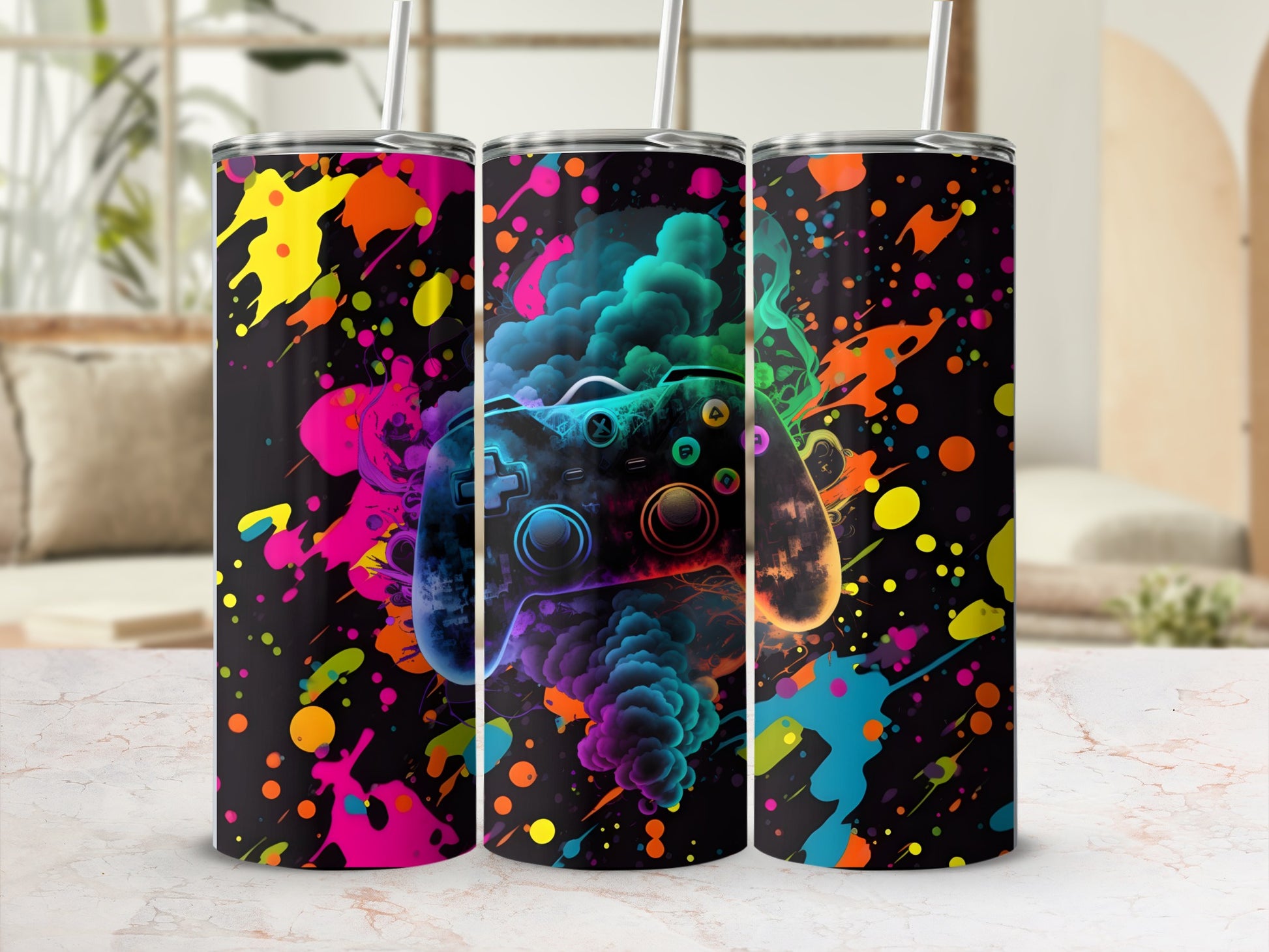 Three tumblers featuring a colorful, abstract paint splatter design and a video game controller graphic.