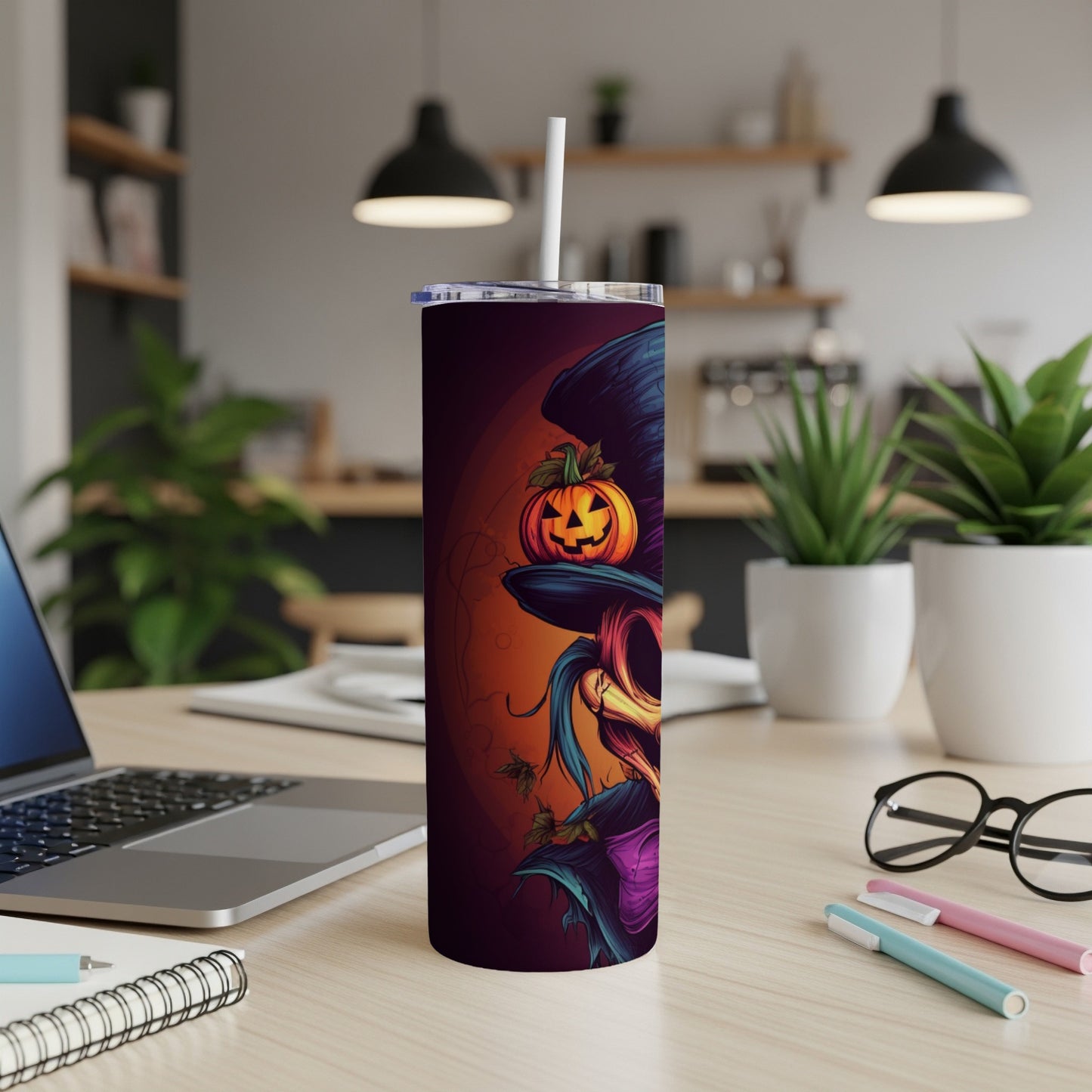 Tumbler with a Halloween witch and pumpkin design, a straw.