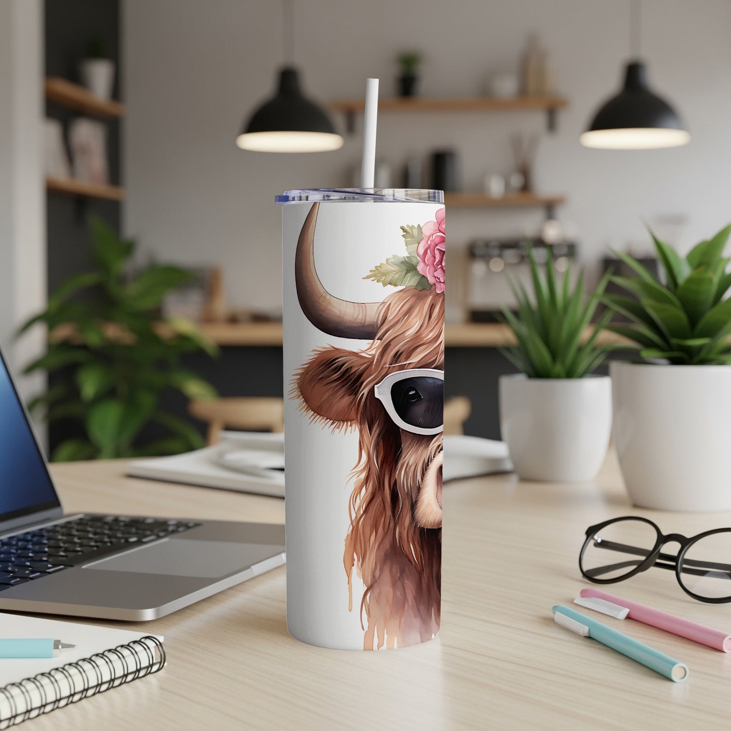 Highland cow with sunglasses and flowers on a white tumbler.