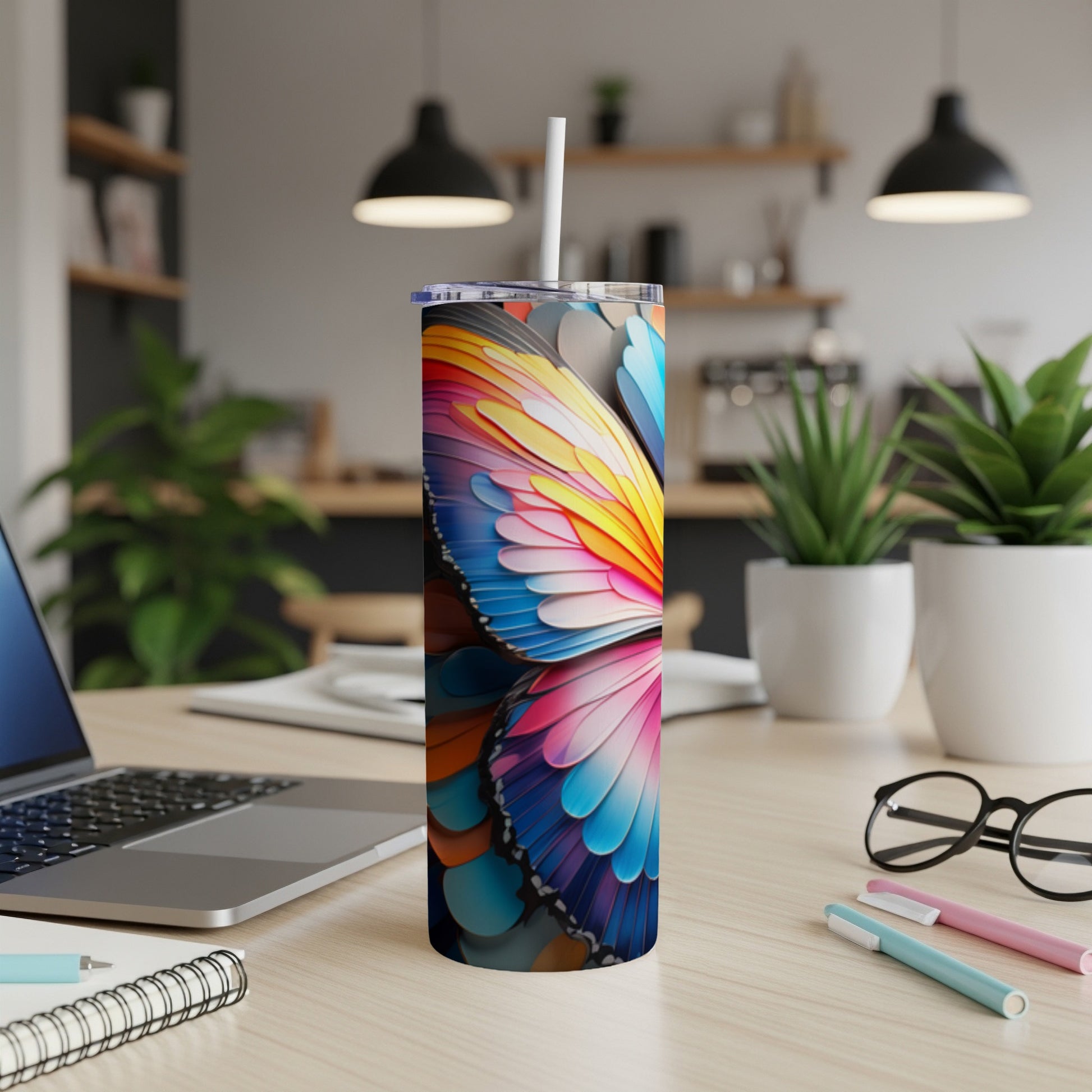 Colorful butterfly wing pattern on a stainless steel tumbler.